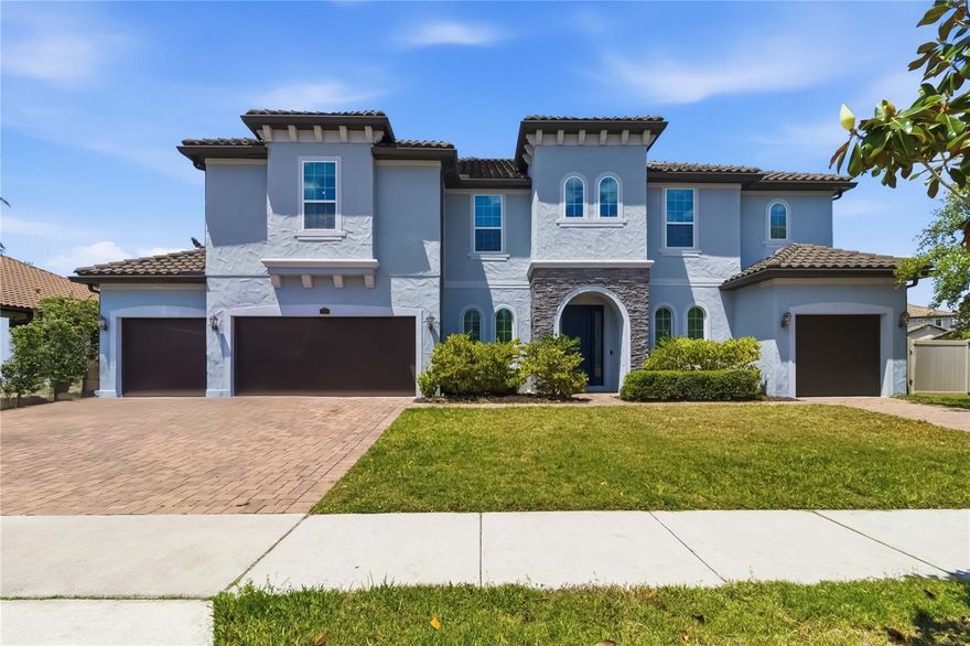 One or more photo(s) has been virtually staged. Step into a standout residence in the gated community of Oviedo Gardens, where refined
design meets everyday comfort on a sprawling fenced corner homesite just under half an acre.
Offering 7 oversized bedrooms, a dedicated office, formal dining room, upstairs loft, custom
movie theater room, 2 spacious living areas, and 5 full bathrooms across 4,933 square feet, this
home delivers exceptional space and flexibility at every turn. From the moment you arrive, the
impressive curb appeal and 5-car split garage make a lasting first impression. Inside, the home
opens to a bright, flowing layout where the main living area seamlessly connects to a beautifully
appointed kitchen designed to be the true heart of the home. The kitchen showcases a stunning
oversized granite waterfall island that serves as both a striking focal point and functional
gathering space, along with breakfast bar seating, stainless steel appliances, double ovens,
abundant cabinetry, generous counter space, a walk-in pantry, and a butler’s pantry for added
convenience and storage. Just off the garage entry, a thoughtfully designed mudroom/drop zone
with built-in cabinetry helps keep everyday living organized, while the large laundry room
provides even more functionality. The main level also features a private office and an expansive
primary suite conveniently located on the first floor. Designed for comfort and luxury, the primary
retreat includes dual vanities, a soaking tub, a separate walk-in glass door shower, and an
oversized extended walk-in closet. Every bedroom throughout the home is generously sized and
features its own walk-in closet, creating comfort and storage for everyone. Hardwood stairs
paired with open iron railings add an elegant architectural touch as you head upstairs, where a
versatile loft anchors the additional living space alongside the oversized secondary bedrooms
and an exceptional soundproof movie theater room complete with a built-in raised seating ledge
for the ultimate cinematic experience. All 5 full bathrooms are beautifully finished with walk-in
glass door showers, enhancing the home’s upscale feel throughout. Out back, the fully fenced
backyard offers privacy and endless possibilities for entertaining, relaxing, or creating your
dream outdoor oasis. Ideally located near SR-417, University of Central Florida, Oviedo on the
Park, Winter Springs Town Center, and Waterford Lakes Town Center, this exceptional home
combines luxury, convenience, and access to highly regarded schools.