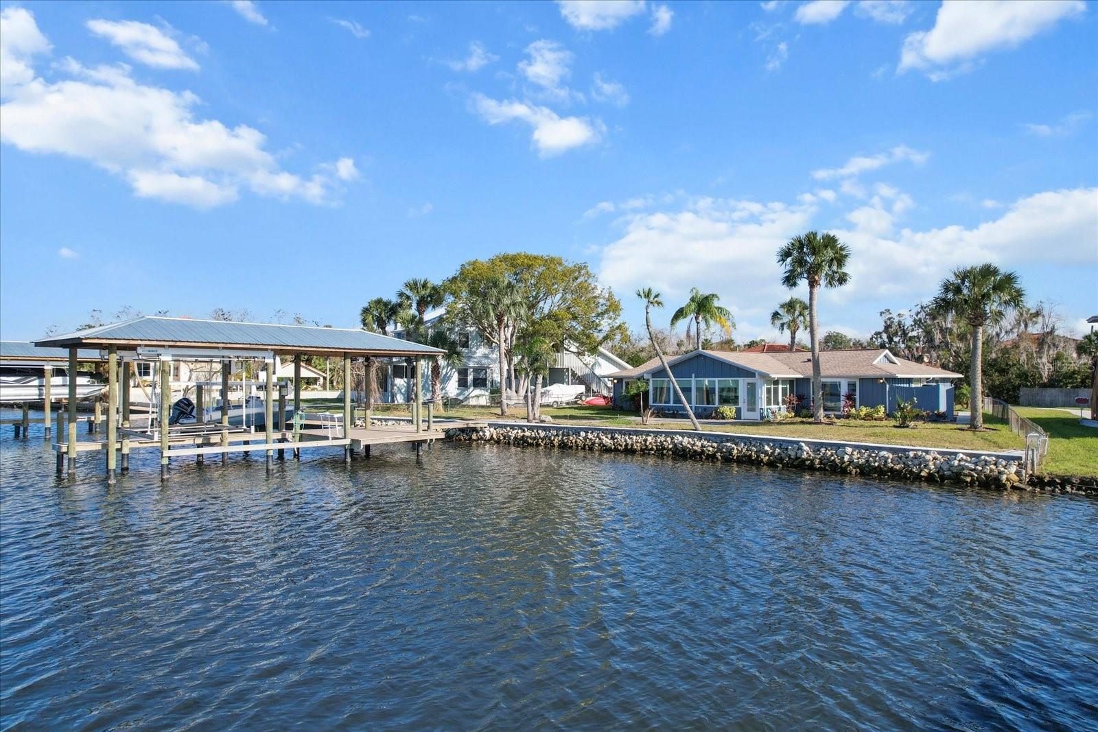“Riverfront” says it all! Opportunities like this don’t come around too often! Direct Access to the Gulf of Mexico from your backyard with 110’ of brand new seawall. Launch your boats from either of your TWO boat lifts to be on the river in seconds from your backyard. Experience waterfront living at its finest in this beautiful 3-bedroom, 2-bathroom home located along the scenic Homosassa River. The home is located within the gated community of Tradewinds Resort with full access to the community pool and amenities with NO HOA fees. With breathtaking views from nearly every room, this home offers the perfect blend of tranquility and adventure, making it an ideal retreat for boating, kayaking and all water enthusiasts. The home features open-concept living and dining areas, perfect for entertaining. Expansive new Florida sun approved windows invite spectacular river views from all areas of the home. This fully furnished home could become an investment opportunity too! A unique & rare opportunity to embrace the Florida waterfront lifestyle. Whether you’re looking to fish, scallop or kayak, this riverfront home is your gateway to endless outdoor fun. Experience a front-row seat in your backyard to Florida's natural beauty. The fresh water at the headsprings of the Homosassa River are minutes away, home to hundreds of manatees during the cooler months of winter. The home experienced flooding during the recent hurricane, but many repairs have already been made. While some finishing touches are still needed, this is a fantastic opportunity to put your personal mark on a property with great potential in the desirable location of Old Homosassa. Take advantage of this unique chance to own a riverfront home with endless possibilities!