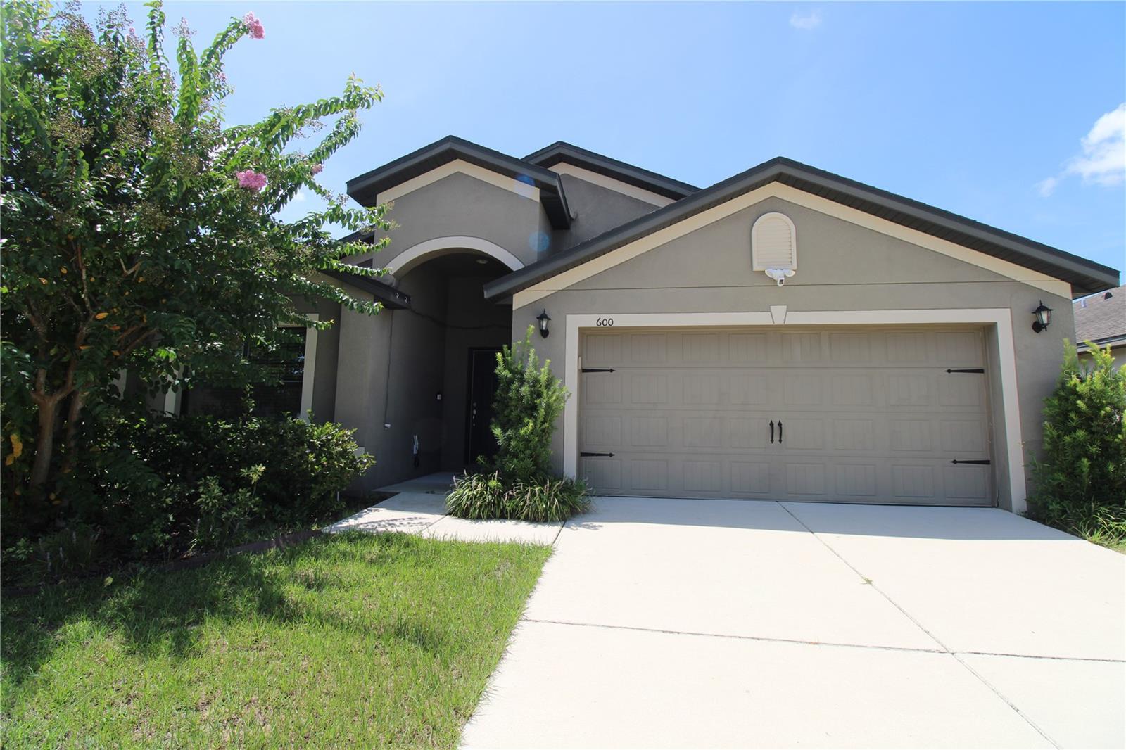 Welcome to this fantastic 4-bedroom, 2-bath home offering over 1,900 sq. ft. of thoughtfully designed living space. Built in 2017, this home combines modern comfort, low-maintenance living, and excellent energy efficiency.
The spacious 15’x19’ great room sits at the heart of the home, connecting seamlessly to the kitchen, breakfast nook, formal dining area, and the 2-car garage. Bedroom #4 offers flexibility — perfect as a private office, playroom, or den.
The chef-inspired kitchen features a breakfast bar, granite countertops, double-bowl under-mount sink, energy-efficient appliances, and sleek handle-less cabinetry for a clean, modern look. Glass doors in the great room fill the space with natural light and open to a covered lanai — ideal for morning coffee or hosting friends — with views of the lush backyard.
The serene master suite includes a large walk-in closet and a stylish bath with dual vanities and a step-in shower. Guest bedrooms have double-door closets and share a full bath. Wood-look floors, upgraded carpet, and 6-panel interior doors add both style and durability.
Community amenities include ponds, a dog park, sports fields, community pool, cabana, walking trails, and conservation areas. Located just minutes from shopping, dining, healthcare, movie theaters, and major attractions like Disney and Universal. Easy access to I-4 ensures a quick commute to employment centers.