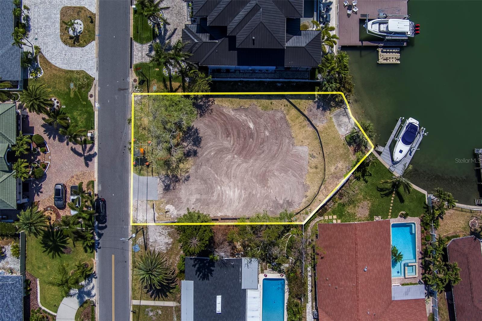 Discover an exceptional opportunity to own a piece of waterfront paradise at 909 Oakwood Drive in the sought after Harbor Bluffs community of Largo, FL. This cleared, vacant lot offers 46 feet of water frontage, complete with a seawall installed in 2014 and the potential to build your own private dock. Nestled among multi-million dollar homes, this rare offering provides the perfect canvas to build your dream residence in one of the area's best neighborhoods. Enjoy easy access to world-famous Gulf beaches, a wide array of top-rated restaurants, and the upscale shops and services of The Plaza in Belleair Bluffs—all just minutes away. Whether you're looking to create a luxurious coastal retreat or an investment in an elite location, this property delivers unmatched potential and lifestyle. Make it yours today!