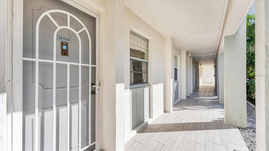 Turnkey two-bedroom, two-bath residence in a first-floor, walkout location. Freshly painted with updated baths and 1,172 square feet of living space. Enjoy direct access to the harbor-front walking path and deeded beach access with baths, outdoor shower and chair storage. Includes a covered, assigned parking space. Resort-style amenities include a renovated clubhouse with kitchen and presentation space, fitness center, sauna, pickleball and tennis courts, outdoor grilling and entertainment area, kayak and paddleboard launch with storage, billiards, poker room, woodworking shop, library and bike storage. This self-managed community has strong reserves, no special assessments and no water intrusion from the 2024 storm season. Ideally located near Bayfront Park and just minutes from Publix, Longboat Key Town Center and St. Armands Circle.