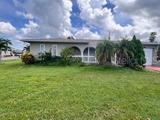 Turnkey Furnished 3-Bed, 2-Bath Pool Home on Oversized Corner Lot! This beautifully maintained home is move-in ready—perfect as a full-time residence or vacation retreat. Step inside to an open floorplan that blends comfort and style, featuring updated flooring throughout and a spacious living area with a stunning floor-to-ceiling window that fills the space with natural light.
The kitchen is a chef’s delight with granite countertops, ample cabinetry with roll-out shelves, and a large window that overlooks the sparkling pool. Adjacent, the open dining area offers sliding glass door access to the screened lanai, where you’ll find a fully equipped outdoor kitchen with running water and a gas fireplace—ideal for entertaining or relaxing poolside. The private primary suite boasts a large updated bathroom, generous his-and-her closets, and direct access to the pool area through sliding glass doors. Two additional bedrooms are smartly designed with Murphy beds, providing flexible use as guest rooms, home offices, or hobby spaces. Storage is abundant throughout, including a large outdoor workshop/storage building. Ideally located close to shopping, dining, medical facilities, and with easy access to US 41, I-75, and the stunning beaches of Southwest Florida—this home truly has it all!