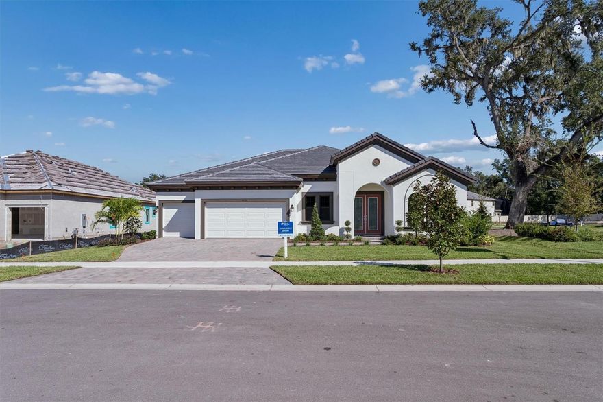 Key Largo I - 
This Key Largo I is ready for move-in! The Key Largo I redefines what a traditional Florida home can be, blending classic charm with modern living through its thoughtfully designed open concept layout. The moment you enter, the residence impresses with its expansive scale, instantly welcoming you with soaring 12 foot ceilings that flow seamlessly through the foyer, formal dining room, grand room, and the expertly designed kitchen, creating an inviting atmosphere perfect for both daily living and memorable entertaining. Your private sanctuary awaits in the owner's retreat, accessed through elegant double door entry. This luxurious space is designed for ultimate relaxation, boasting two spacious walk in closets and a lavish ensuite bath. Beyond this serene haven, you will find an oversized laundry room and a generous covered lanai, ideal for enjoying the beautiful Florida weather year round. For added flexibility, an upgraded bonus room allows you to truly customize your home to fit your unique lifestyle, whether you dream of a dedicated home office, a vibrant media room, or a private gym. Every detail in the Key Largo I has been thoughtfully curated, blending intentional design with high end finishes. Imagine the warmth of Nutmeg Luxury vinyl plank flooring flowing throughout the main living areas, beautifully complemented by stylish Maddox Painted Harbor cabinetry and stunning Frost Whte MSI Quartz countertops. This harmonious combination creates an environment that is both elegant and wonderfully welcoming. Don't miss your chance to experience the Key Largo I, where thoughtful design meets impeccable style and your best life begins. Listing Price amount for this Pending Sale includes Design and Structural Options.