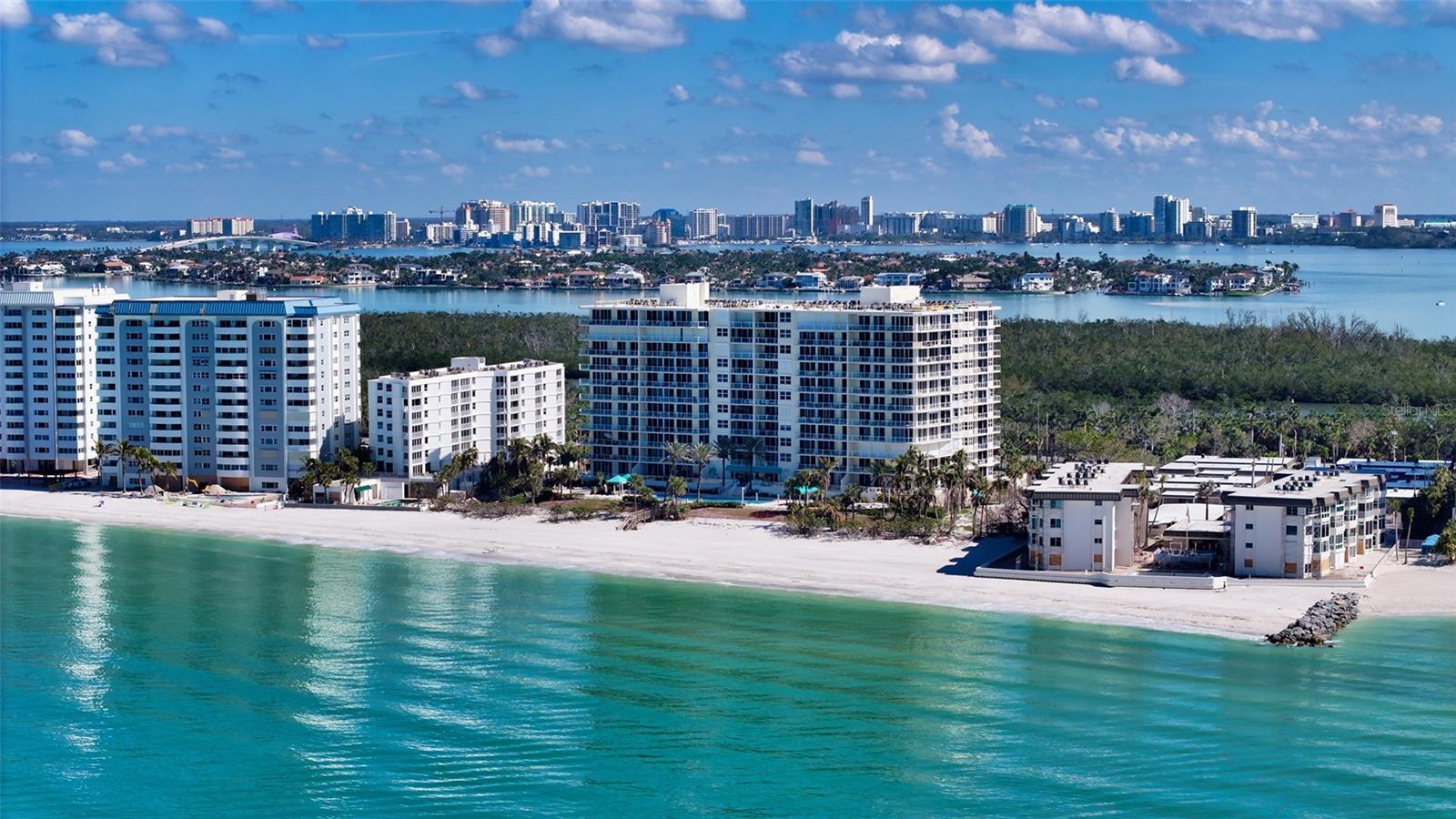 Experience refined coastal living at its finest on Lido Beach! This exquisite 3-bedroom, 2.5-bath condominium residence at L' Elegance is impeccably maintained and offers a captivating 39-foot terrace with views of the lush South Lido Park, Ringling Bridge and downtown Sarasota. With timeless style, the kitchen features bright white cabinetry, granite countertops and ceramic tile backsplash and stainless appliances. The spacious primary suite is a serene retreat, complete with a generous walk-in closet, a sumptuous soaking tub, a separate shower, and dual vanities for ultimate convenience. Additional highlights include a dedicated inside utility room with a full-size washer and dryer for added practicality. L'Elegance offers an exceptional array of community amenities, including two well-maintained, lighted Har-Tru tennis courts, a heated Olympic-size pool overlooking the pristine beach, and a sophisticated Gulf-view entertainment area perfect for social gatherings. Stay active in the state-of-the-art fitness center, complete with men's and women's saunas, while benefiting from 24/7 security at the guard-gated entrance. For added convenience, secure under-building parking is provided. Nestled on 400 feet of private beach along the breathtaking Gulf of Mexico, L'Elegance is bordered by the vibrant, unspoiled beauty of the South Lido Park nature preserve to the east. This serene park offers picnic pavilions, playgrounds, sand volleyball courts, and BBQ grills nestled under towering Australian Pines. At the northern end of the park, visitors can immerse themselves in the natural splendor along scenic nature trails, boardwalks, and enjoy a canoe/kayak launch with a self-guided trail. Pet-friendly and offering the perfect balance of luxury and nature, this residence is the epitome of an idyllic coastal lifestyle! St. Armands, Longboat Key, and Downtown SRQ are a quick car ride for enjoying the area's vast array of fine dining, shopping, recreational and cultural activities. This is a wonderful opportunity to find out why L' Elegance is the most desirable condominium on Lido Beach.