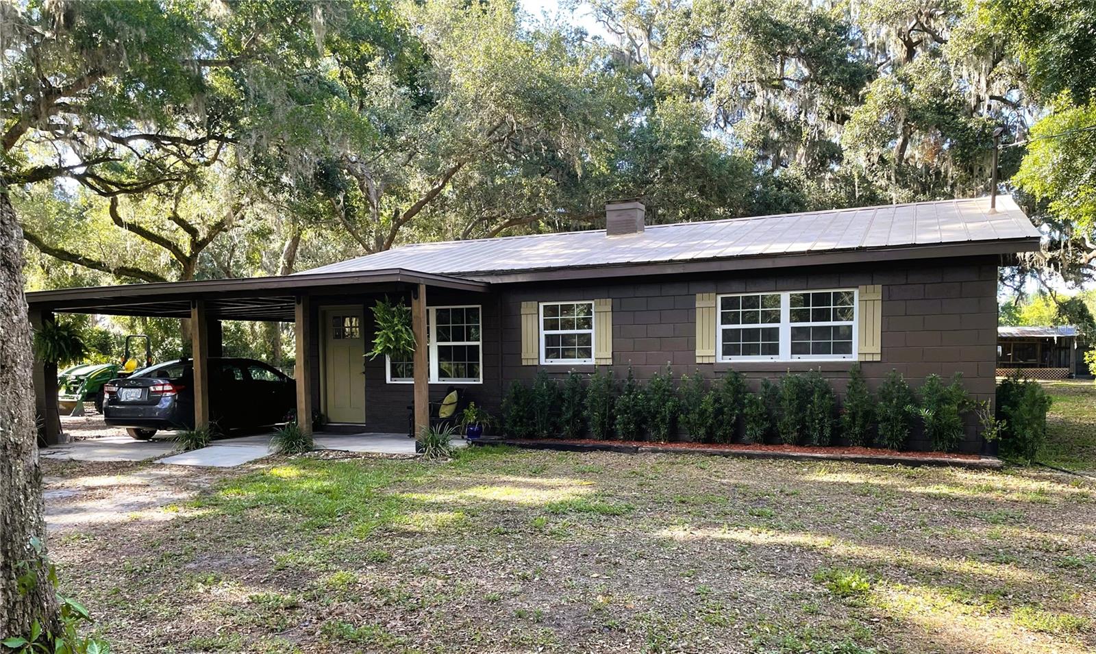 Welcome to your private retreat! Tucked away at the end of a quiet dead-end street, this charming concrete block constructed 2-bedroom, 1-bathroom home sits on 14 beautifully manicured acres, surrounded by majestic grandfather oaks in a serene, park-like setting. Best of all, this property is not located in a flood zone, offering peace of mind for years to come. The home features a separate laundry room and a dedicated office space, perfect for remote work or use as a nursery/child's room. With upgraded insulation, energy-efficient A/C, and a modern water heater, comfort and efficiency are built in. The durable metal roof provides lasting protection. The property is fully fenced and cross-fenced, providing privacy and security. It includes a stall, paddock area and a large chicken enclosure ideal for animals or hobby farming. A 32' long shed/workshop offers plenty of space for storage, projects, or creative endeavors. Accessed via a remote gated entry, this property provides the perfect balance of seclusion and convenience. Whether you're looking for a peaceful retreat or a place to nurture your passions, this stunning property has it all. Don’t miss out on this rare find!