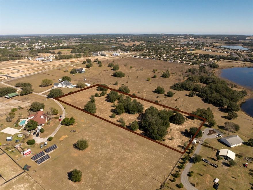 Capture the essence of Florida’s rolling hills and serene landscapes with this exceptional 5-acre vacant land opportunity on Starcrest Ln in Minneola. Perfectly situated just off Wilson Lake Parkway, this expansive parcel offers a rare combination of privacy and accessibility. This high and dry lot provides the ultimate blank canvas for your custom dream home, where you can finally bring your vision to life.As showcased in our aerial footage, the property boasts an incredible elevation that overlooks the shimmering waters of Deacon Lake. Imagine waking up to sweeping views and enjoying spectacular sunsets from your own private hilltop retreat. This isn't just a lot; it's an invitation to a lifestyle defined by space and tranquility. Despite the quiet, rural feel, you are never far from convenience. The property is located approximately 2 miles from Hwy 27 and roughly 4.5 miles from the Southbound Turnpike entrance, making commutes to Orlando and surrounding areas a breeze.Whether you are looking to build a sprawling modern estate with a resort-style pool or a charming farmhouse with a wraparound porch to soak in the views, these 5 acres provide the room you need to grow. Large, established trees dot the landscape, adding natural character and shade to the terrain. Don't miss your chance to secure one of the area's most desirable "biggest requests"—a high-elevation lot with a view. DM us today to bring your vision to life and start building the future you’ve always pictured.