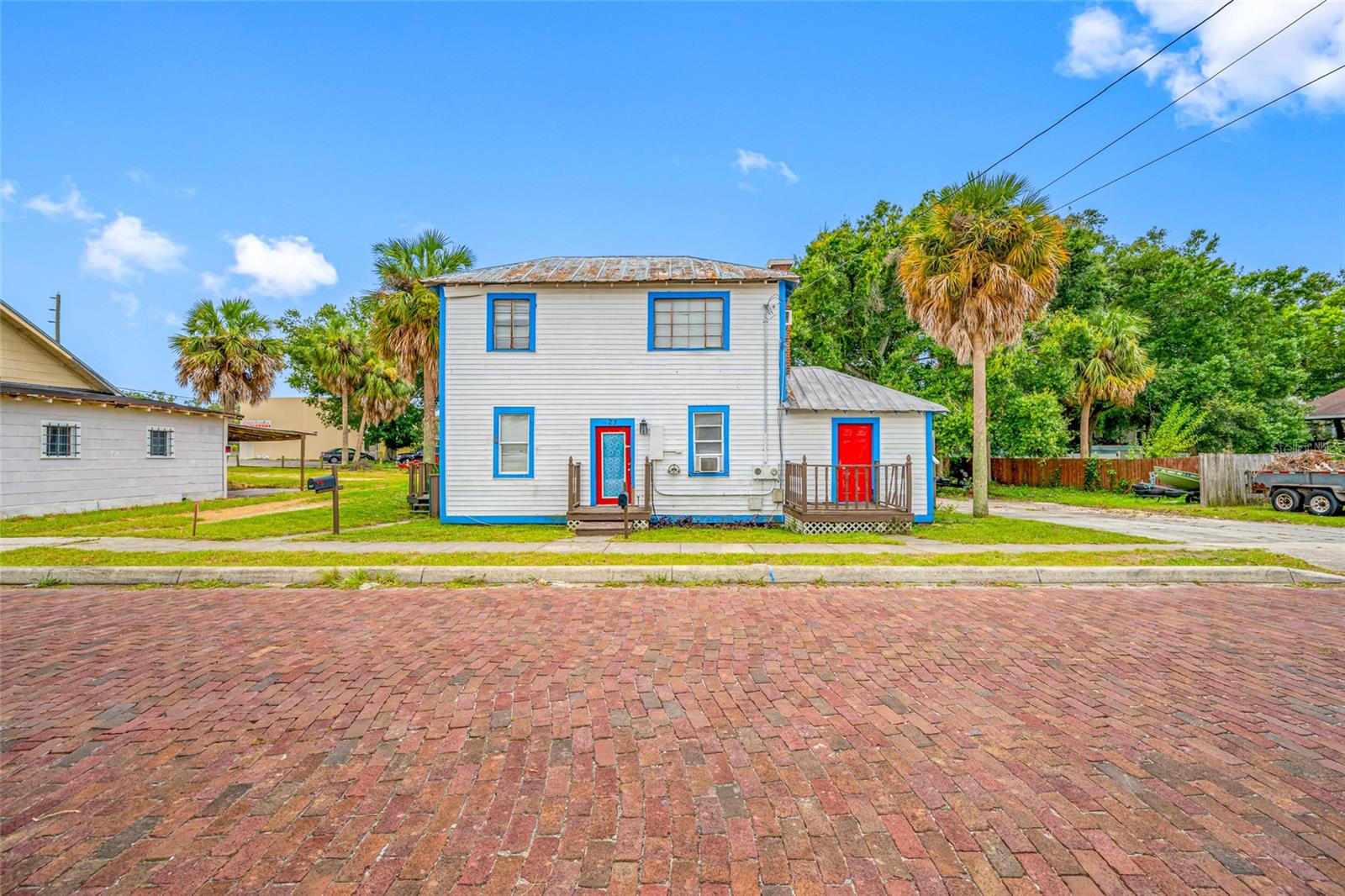 This building centrally located with a short walk to both downtown and to the Historic Sponge Docks. The space includes 2 small residential rental units or office space, plus a large warehouse/workshop. Each unit is 1 Bedroom and 1 Bath, one upstairs and the other down with separate private entrances. Included is the adjacent vacant parcel to create parking for your business or a green space for your residential tenants.