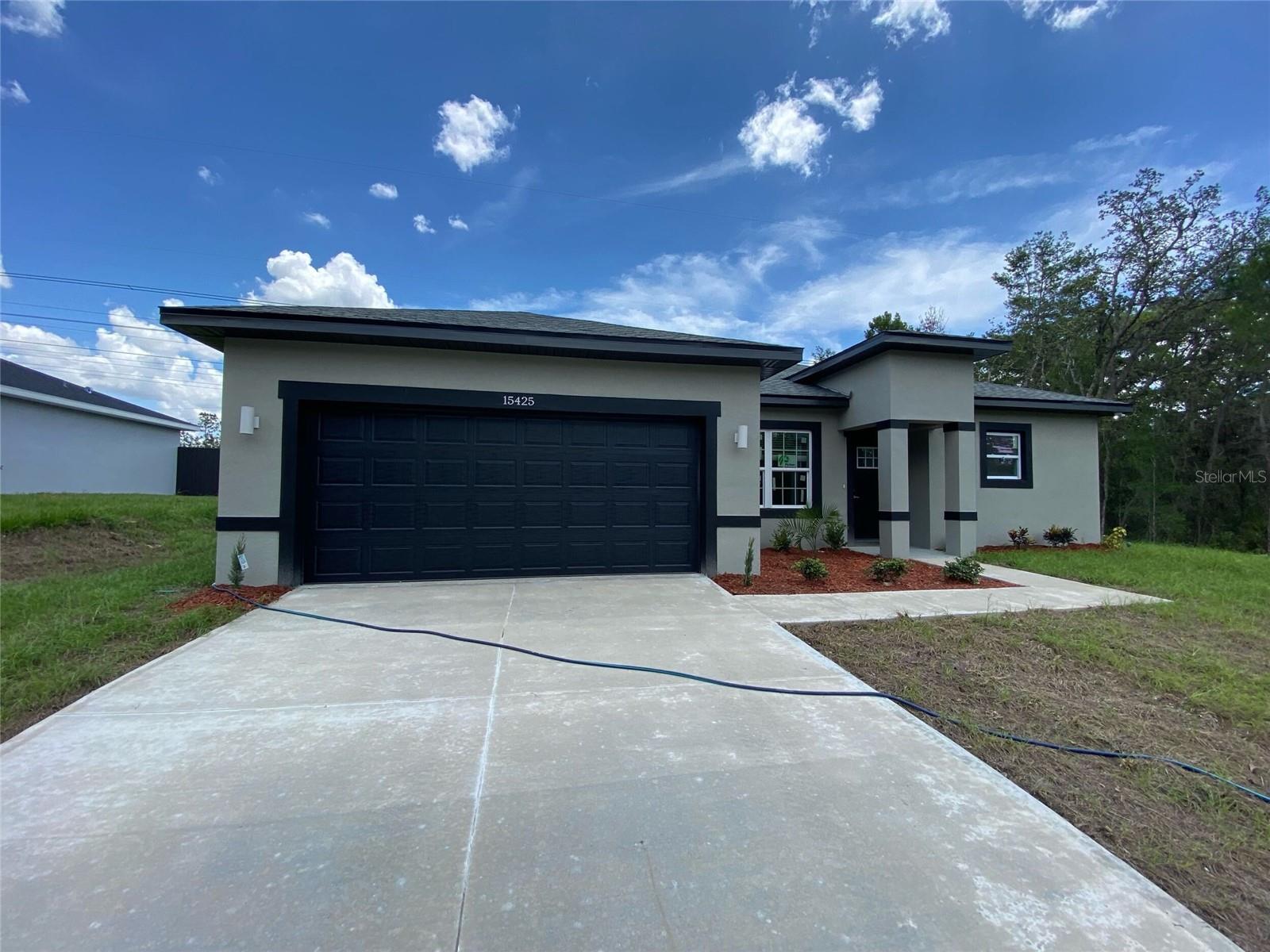 Under Construction. Brand-new house in Ocala! This stunning home combines modern style and convenience with 4 bedrooms and 2.5 bathrooms. The master bathroom is a true retreat, featuring a stunning STANDALONE TUB and a sleek SHOWER DOOR for added style and functionality. The spacious open floor plan is perfect for hosting large family gatherings, and the fully equipped kitchen includes stainless-steel appliances—refrigerator, range, disposal, dishwasher, and microwave. Additional features include a SMART KEY system for enhanced security and convenience. Don’t miss out—schedule a showing today!