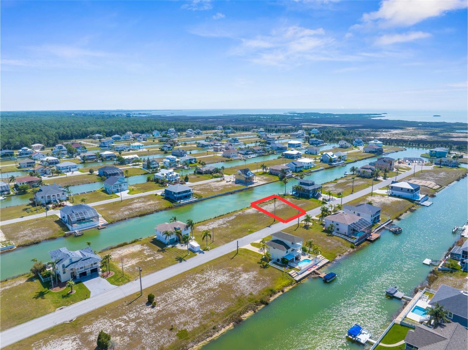 Build your dream waterfront home in Hernando Beach South, Florida. This 7,500 sq ft residential lot is zoned R1B for single-family homes and offers 75 feet of canal frontage with indirect Gulf access via the community boat lift. The HOA fee is approximately $330 a year, providing amenities like a community boat slip and lift, and maintenance of vacant lots until construction begins. Enjoy serene waterfront living with opportunities for kayaking and boating right from your backyard. Just minutes away, explore the crystal-clear waters of Weeki Wachee Springs State Park, perfect for paddling and observing local wildlife. This lot provides the perfect setting for a coastal lifestyle, combining peaceful living with easy access to outdoor adventures.