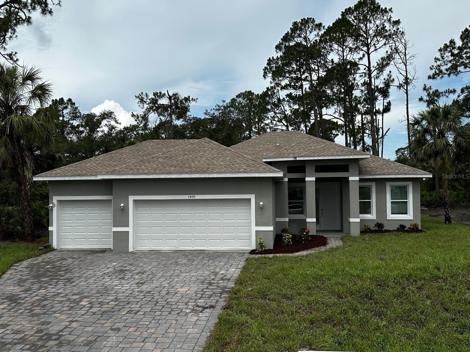 Under Construction. Stunning 1,839 SF living space, with 3 car garage, featuring 3 bedrooms, 2.5 baths, and a flexible den—perfect as a home office or 4th bedroom. Open-concept layout with a spacious kitchen, island, and stainless steel appliances including refrigerator, range, microwave, dishwasher, and disposal. Primary suite includes a glass-enclosed shower. Enjoy Florida living with an inviting 290 sq ft covered lanai, perfect for outdoor relaxation, and a welcoming 82 sq ft entry. The attached three-car garage offers 655 sq ft of space, providing room for vehicles, storage, or a home gym. With a total constructed area of 2,866 sq ft, including non-living areas, this home is built for comfort and convenience. Additional features include a SMART KEY security system for peace of mind. Don't miss the chance to make this stunning home yours—schedule your private tour today!