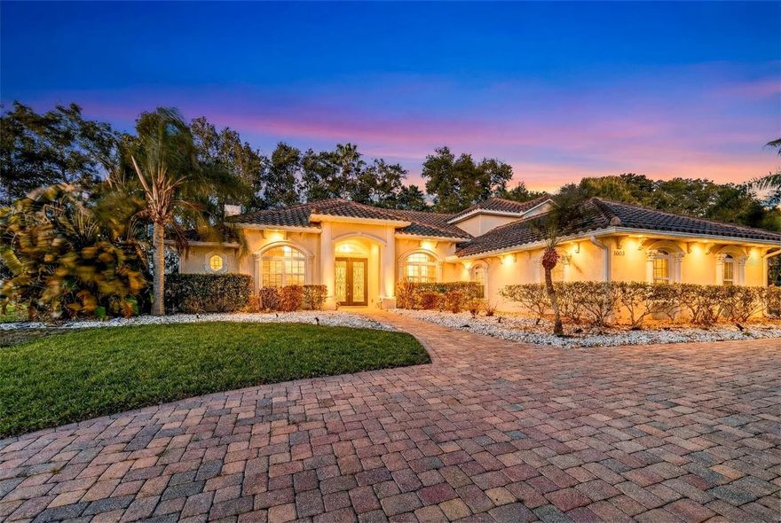 One or more photo(s) has been virtually staged. GORGEOUS, GATED MEDITERRANEAN HOME IN GARDEN CITY WITH CHAIN OF LAKES LAKE STEWART/ CHERRY LAKE VIEWS FEATURING CIRCULAR DRIVEWAY, 3 CAR GARAGE, INGROUND POOL WITH SUMMER KITCHEN AND 2 SIDED PRIMARY BEDROOM GAS FIREPLACE!  THIS HOME IS A STUNNER...FROM THE MOMENT YOU DRIVE UP YOU ARE EMBRACED WITH THE LUXURY AND ELEGANT LIFESTYLE OF THIS GAATED LAKE VIEW HOME!
MATURE LANDSCAPING, PAVER CIRCULAR DRIVEWAY AND SIDE ENTRY 3 CAR GARAGE IS THE BEGINNING. LEADING TO DOUBLE GLASS DOORS FRONT COVERED ENTRY STEP INSIDE THIS CUSTOM HOME AND YOU ARE GREETED WITH REAL HARDWOOD FLOORS, VAULTED CEILINGS, AND YOUR OWN PRIVATE OFFICE TO THE LEFT WITH DOUBLE GLASS DOORS. STRAIGHT AHEAD IS THE FORMAL LIVING AREA OVERLOOKING THE POOL AND TO THE RIGHT IS THE FORMAL DINING WITH TRAY CEILING. FROM THE PRIVATE OFFICE THERE IS A CONVENIENT DOOR LEADING TO THE SPACIOUS AND LUXURIOUS PRIMARY BEDROOM FEATURING TRULY A SPA LIKE BATH EXPERIENCE WITH LARGE SOAKING TUB WITH CUSTOM COLUMNS, VIEWS AND WARM OF A 2 SIDED GAS FIREPLACE. TILE SURROUND SHOWER WITH MULTIPLE SHOWER HEADS AND GLASS DOOR.  DOUBLE SEPARATE VANITIES AND 2 LARGE CUSTOM WALK IN CLOSETS. THE 2ND AND 3RD BEDROOMS WITH HARDWOODS FLOOR SHARE JACK N JILL DOUBLE VANITY BATH WITH COMBO TUB/SHOWER WITH SLIDING GLASS DOORS. MAKING YOUR WAY BACK THROUGH THROUGH THE FORMAL LIVING AND DINING THERE IS A 1/2 A BATH . THE AMAZING LAUNDRY ROOM WITH UTILITY SINK HAS CUSTOM CABINETS, A MUD ROOM AREA AND PLENTY OF WORKABLE AREAS LEADING TO 3 CAR GARAGE. LET'S TALK ABOUT THE KITCHEN FEATURING A MASSIVE ISLAND WITH PENDANTS, CUSTOM BACKSPLASH, STAINLESS STEEL APPLIANCES, STAINLESS RANGE HOOD FOR COOKTOP AND BUIT IN DESK AREA. THERE IS SO MUCH GRANITE COUNTER SPACE ITS IMPRESSIVE. PERFECTLY POSITION IS BREAKFAST AND AND 2ND LIVING/FAMILY ROOM. THE 4TH BEDROOM IS OFF OF FAMILY ROOM AND IS THE HOME TO ITS OWN PRIVATE ENSUITE BATH WITH DOOR LEADING TO POOL. GREAT BATH FOR KEEPING THE WET FEET ISOLATED.  OFF OF KITCHEN ARE WOOD FLOOR STEPS LEADING TO THE SECOND FLOOR LIVING AREA WITH SECOND STORY BALCONY WITH BEAUTIFUL VIEWS OF LAKE STEWART. IN THIS AREA THERE IS A SPACIOUS LIVING ROOM, BAR AND 5TH BEDROOM WITH 4TH FULL BATH. THIS COULD POTENTIAL BE A GREAT TEEN AREA OR IN LAW SUITE. DROPPING BACK DOWN STAIRS TO OUTSIDE EITHER THROUGH FAMILY ROOM FRENCH DOORS OR FRON THE LIVING ROOM DOORS TO THE COVERED LANAI FEATURING SUMMER KITCHEN WITH GRILL WITH HOOD, REFRIGERATOR AND OUTDOOR DINING AREA. THE SCREENED IN POOL IS PRIVATE AND HAS A HOT TUB FOR YOUR ENTERTAINMENT NEEDS. THIS PROPERTY IS THE BEST OF THE BEST AND  PRICED TO SELL! LAKE VIEWS AND LAKE LIFE IN A HIGHLY SOUGHT AFTER GATED COMMUNITY! COMMUNITY HAS COMMUNITY BOAT RAMP, FISHING PIER WITH COVERED DOCK AS WELL. ALL WATER ACCESS LEADSFROM CHERRY LAKE TO CHAIN OF LAKES ACCESS!