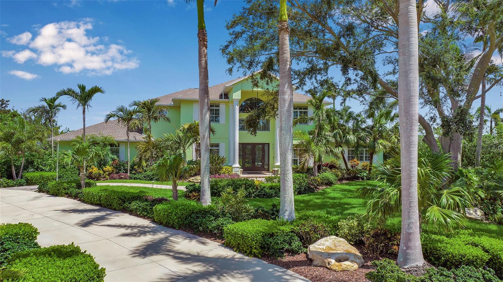 Exceptional Lakefront Estate in The Loop of Northwest Bradenton! Tucked away at the end of a quiet cul-de-sac in the exclusive gated community of The Loop, this one-of-a-kind 5-bedroom, 4 full and 2 half-bath estate sits on over an acre with sweeping lake and preserve views. Impeccably maintained and thoughtfully upgraded, this home combines timeless design, luxurious finishes, and modern conveniences for a truly elevated lifestyle. Enter through stately double French doors into a grand two-story foyer showcasing rich cherry hardwood floors, elegant crown molding, wide baseboards, and custom casings. Light flows through Pella windows and plantation shutters throughout, giving this home a warm and inviting ambiance. At the heart of the home, the chef’s kitchen is both functional and beautiful—featuring solid wood cabinetry, quartz countertops, a walk-in pantry, recipe desk, touchless faucets, wine cooler, and new stainless steel appliances. The large eat-in area overlooks the stunning pool and lake beyond—ideal for daily family life or elegant entertaining. The spacious primary suite is a retreat unto itself with a cozy double-sided fireplace, a soaking tub, walk-in shower, expansive walk-in closets, and a private balcony for sunset views and wildlife watching. This home was designed for fun and relaxation, offering a private media room with surround sound, reclining theater chairs, and remote-control blackout drapes, as well as a large dedicated office ideal for working from home. Step outside to your brand-new $130,000 two-story panoramic screen enclosure, framing a huge heated saltwater pool and spa, perfect for year-round enjoyment. Immaculately landscaped with mature palms, lush tropical foliage, and landscape lighting, the backyard feels like a private resort. The oversized 3-car garage (including one bay 18' wide with a 9' tall door) easily accommodates a lifted truck, and features a private bathroom, storage, and even a Tesla fast charger. Located 2 minutes from Robinson Preserve, Palma Sola Botanical Park, and just 7 minutes to the gorgeous white sandy beaches of Anna Maria Island. This home truly offers the best of luxury, location, and lifestyle in one of Bradenton’s most sought-after neighborhoods.
