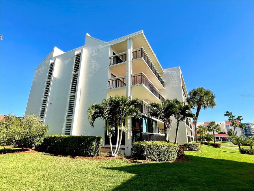 Welcome to the largest and rarely available corner unit in Harbourside, offering 1,445 sq ft of living space, 2 oversized bedrooms, and an expansive 180 sq ft glass-enclosed Florida room. This beautifully updated first-floor residence lives like a private villa and is located in the highly sought-after waterfront community of Harbourside.

From the moment you step inside, you’re greeted by a modern, updated kitchen featuring sleek gray wood cabinetry, granite countertops, a breakfast bar, and stainless steel Samsung appliances (just 2 years old). A cozy café-style eat-in nook adds charm and functionality. The spacious living and dining area is enhanced by luxury vinyl flooring and elegant crown molding, and flows effortlessly into multiple seating areas—perfect for both relaxing and entertaining. A cozy fireplace anchors the oversized living room, creating a warm and inviting atmosphere.

The primary retreat offers generous space, a walk-in closet, and a beautifully updated en-suite bath with granite countertops and a glass-enclosed shower. The second bedroom is equally impressive—large enough for a king-sized bed—with a built-in office space and its own full walk-in closet. The guest bathroom stands out with a stylish glass bowl sink and a jacuzzi tub as a statement feature.

Enjoy true indoor-outdoor Florida living with a large enclosed sunroom plus a separate covered patio, where you can relax and take in lush greenery and peaceful bay views. Additional upgrades include hurricane-impact windows and major systems—AC, water heater, and electrical panel—all replaced in 2020,.

Residents of Harbourside enjoy resort-style amenities in a guard-gated setting, including a 1.5-mile waterfront walking trail, tennis, pickle ball and shuffleboard courts, heated pool & spa, 2 fitness centers with sauna, clubhouse with social activities, and a full-service marina. The home also includes a private carport directly in front of the building, ample guest parking, and EV charging stations. The condo fee incorporates extensive recent upgrades—including a new roof, building painting, and electrical updates—as well as completed milestone compliance, enhancing long-term value. Strong reserves have been established, and comprehensive financials are available for review.

This is the largest corner unit in Harbourside, combining space, upgrades, and an unbeatable lifestyle. A rare opportunity to own a piece of paradise.