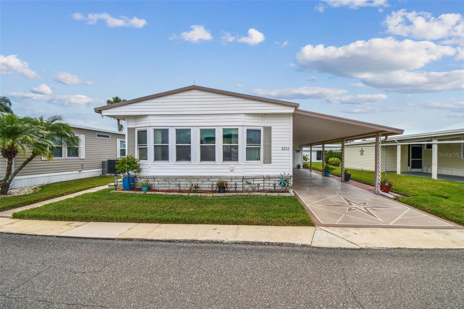 Water view! New LVT flooring! New windows, storage room/shed, primary bedroom with walk-in closet, newer HVAC system with UV light, new dishwasher! Carport with 2-3 covered spaces, separate screened lanai! Bonus space on enclosed porch with serene water views!