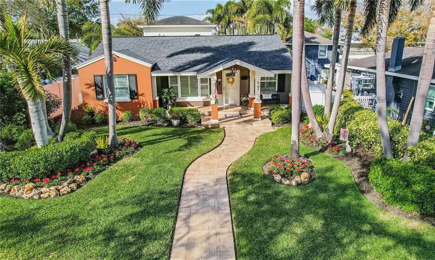 Beautifully landscaped and meticulously updated single family home in prime high & dry location of Five Points neighborhood; which consists of a mix of brand new builds and existing older homes, and within a block or so distance to major grocers (Fresh Market, Trader Joe's ), restaurants, doctors/dentists/eye care & much more along the 4th St. corridor. This home fits in perfectly for a "not too big and not too small" aesthetic.  Originally built in 1947, it was purchased in 1999 by the current owners and has undergone multiple renovations to not only enhance and update the original build, but also to add on the newer additions. Engineered hardwood has been installed throughout the main home (2021).  Additional updates include tankless natural gas H20 (allowing extra room for a storage pantry off the kitchen), complete exterior paint (February 2026), new roof main house (March 2020), new roof second story home office (February 2026), New insulation in attic (March 2026), ac ducts brushed, vacuumed & sanitized (Feb. 2026), new primary bathroom totally renovated (2021), new storm-rated double french doors with built-in blinds (Nov. 2025), new kitchen update with beautiful maple quiet close drawers & doors and granite counters (Nov. 2024), newer beverage cooler, disposal & microwave, new range & dishwasher; new pool salt generating system (2025) along with pool re-surfacing and new pool light (2020). Custom made wood plantation shutters and ceiling fans in every room.  Indoor-Outdoor custom speakers for great sound & entertainment as well as 75" flat screen tv outside. A second story 528 sq. ft. home office studio built in 2009 above the garage comes complete with built in storage and desk space has an entrance not only from the garage, but a separate outdoor entrance coming from the expansive parking area. Currently being used as home-based business (and is separate from main house), would also make a great media room, music studio or art studio, and might possibly become an ADU with additional plumbing work. The 528 sq. ft. two car garage features all built-in cabinetry and tool storage, plus stainless sink with large window, Maytag Bravos XL washer-dryer pair, and Samsung stainless refrigerator-freezer for extra food storage. On the opposite wall more storage and counter space.  "Cocktail" pool is a feature in itself, being both in ground but raised enough to seat guests, and features a salt chlorinator generator system and heated by natural gas.  Pool will heat up to 104 degrees if you like the feel of a "hot tub" in the winter.  Travertine pavers have been installed in front walkway, front porch, back courtyard and sidewalk along the house, while leaving just enough land/mulch space for a dog to go "outside" using the built-in dog door.  In addition, sprinkler system is on a well in both front and back yards. Back yard is totally enclosed with 6 ft. vinyl fencing. Tropical palms surround the outdoor space creating the feel of an island retreat. Sunbrella fabric custom designed awning covers just the right amount of space over walkways and dining area, leaving an open sky ambiance poolside for a fireside seating arrangement.  In addition, there is parking for a boat approx. 23' plus more cars on the expansive parking pad.  This home has been the host of many social gatherings, as many as 30 guests with indoor/outdoor entertaining, yet has an intimate feel and tons of character.  You will be proud to call this beautiful home yours!