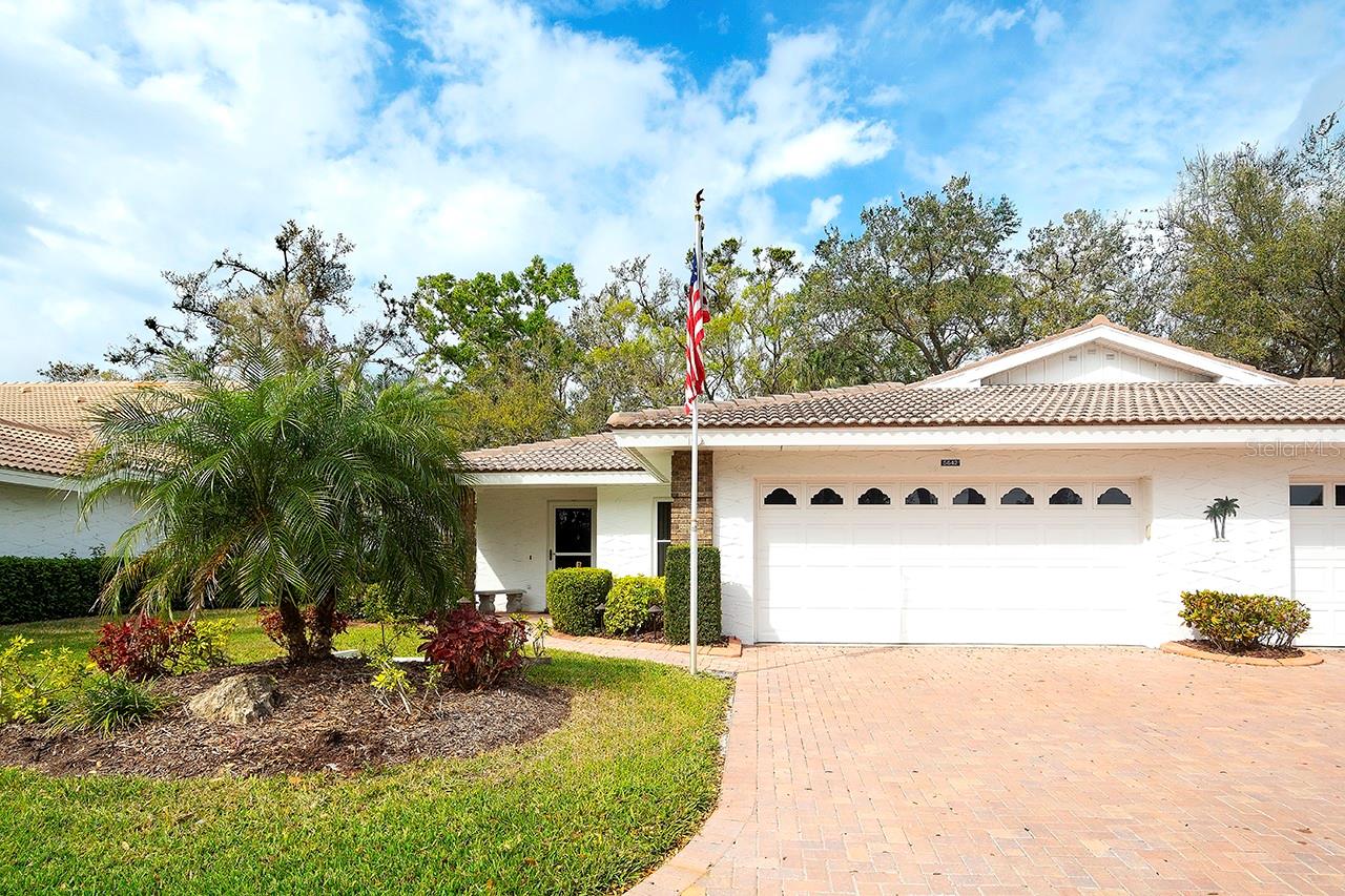 One or more photo(s) has been virtually staged. REDUCED AND MOVE IN READY! Welcome to Garden Lakes – Your "Everyday Vacation Spot" is here! Step into a resort-style, maintenance-free lifestyle in this charming villa, nestled within a secure 55+ gated enclave. Surrounded by lush, mature landscaping and majestic oak trees, this community offers a serene, park-like setting that makes every day feel like a getaway. Come view the FRESHLY PAINTED INTERIOR IN A NEUTRAL "COMFORT COLOR", along with new fans and light fixtures. Discover an inviting open floor plan designed for both relaxation and entertaining. Enjoy three distinct living areas—a formal living/dining space, the cozy family room and an enclosed lanai/sunroom, perfect for quiet moments, relaxation or entertaining. The functional eat-in kitchen, complete with an island, breakfast bar, and new cabinetry paired with solid surface countertops, makes meal preparation a delight. The owner’s suite is a true sanctuary, featuring a generous walk-in closet ,updated vanitiy mirrors, lighting and shower along with direct access to the lanai that overlooks the beautifully manicured grounds. A separate guest suite, with adjacent full bath and a discreet pocket door, ensures privacy for visitors or multigenerational living. Additional features include a 2-car garage, tile roof, luxury vinyl flooring throughout, and high ceilings that add to the sense of space and light. Garden Lakes is designed to elevate your lifestyle with a host of amenities, including: thier updated clubhouse with a full kitchen, dance floor, meeting rooms, and a library that hosts a variety of social events. A heated pool and fitness center. Tennis and pickleball courts, shuffleboard, and scenic walking trails for an active lifestyle. With no CDD fees and low association fees that cover lawn mowing, landscaping, irrigation, basic cable, and exterior painting, you’re free to focus on what truly matters—living life to the fullest. Ideally situated near shopping, dining, medical facilities, University Town Center, I-75, and the stunning Gulf Coast beaches, this villa offers both tranquility and convenience. . Vacant and easy to view, this villa at Garden Lakes is more than just a home—it’s a lifestyle. Enjoy new friendships at community events, classes in the recreation center, and the vibrant social scene that makes Garden Lakes truly special. Call us today to experience the ultimate in Florida living! Roof 2005, Water Hrt 2011, AC New Motor 2022