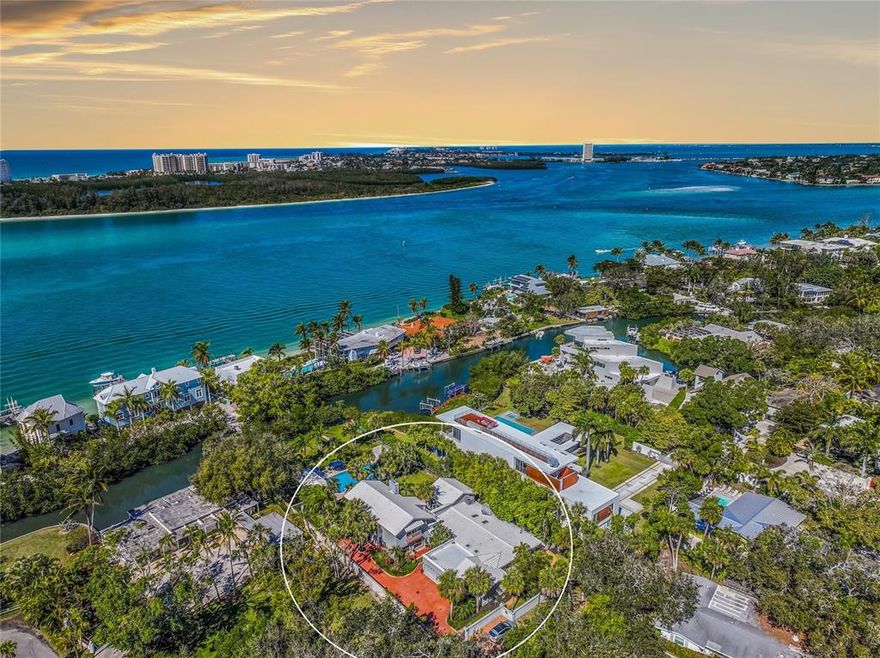 Paradise found! Serenity and privacy abound in this secluded tropical, gated, waterfront estate situated on the highly sought after north end of Siesta Key Island. Only 3.1 miles to Siesta Key beach which is known for its beautiful powdery sand and aqua blue waters. Magnificent estate home showcasing an incredible indoor/outdoor lifestyle with multiple entertaining spaces, private lani’s and fun gathering spaces. Entering the estate, you are welcomed by a grand foyer with incredibly crafted inlaid marble flooring. Natural light streams into this home with multiple skylights, sliding doors, and French doors leading to the multitude of outdoor living spaces. Host magnificent dinner parties in the formal indoor dining room with inlaid marble tiles. With multiple large bedrooms - complete with en-suite bathrooms - there are opportunities to turn any room into the primary bedroom suite, with options for first floor or second floor to take that title. On the lower level you will find a large primary bedroom option equipped with a slate tiled fireplace and covered lani overlooking the pool. Or on the other end of the main level the king room with multiple sets of French doors leading to the quiet and secluded north yard sitting area. There is also a queen bedroom/office on the main with a jack-n-jill bath. The upper king room has a lani overlooking the pool and lush grounds, en-suite bath, tiled 3rd fireplace and large walk-in closet. Upper queen room has a balcony and a terrace, ensuite bath and large closet. Very large pool surrounded by luxurious travertine tiles and extended walk ways from the home, around the pool and to the boat dock. Your private dock will lead you to a 13,000-pound boat lift and plenty of space to store your aquatic toys to enjoy a day out on the water. Access to the Bayou Louise canal is along the rear property line which will lead you to the Big Sarasota Pass and only one fixed bridge to navigate your boat to the Intracoastal Waterway. The calm waters in the canal are ideal for kayaking or paddle boarding where you may see manatee and dolphins while enjoying the Florida sun. Enjoy after dinner walks to Shell Beach only 2 blocks away where you can watch sunsets over Lido Key, passing boats, and dolphins dancing in the water. 15 minute (1.9mile) bike ride to Siesta Key Village for breakfast at unique restaurants. Enjoy the fun shopping, dining and multiple island beaches on the island. And easy 1.9mile bike ride to Siesta Key Village. Siesta Key is part of the greater Sarasota Area with access to incredible dining, shopping, medical facilities, and roadways. You’ll also be close to Downtown Sarasota where the quaint small town feel with delicious restaurants and boutiques are met with the art, live entertainment, and exciting nightlife. ¤ Please see 3D Tour and Video ¤