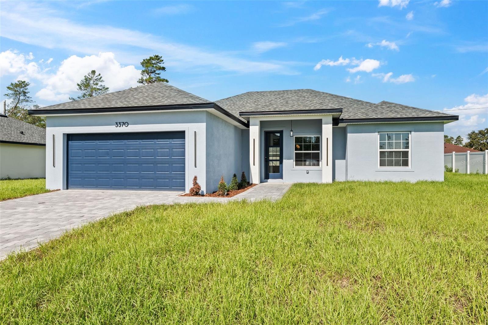 Brand-New and Move-In Ready!
Discover this stunning, newly built 4-bedroom home located in one of Ocala’s most sought-after neighborhoods. Perfect for families and savvy buyers, this property offers the ideal blend of modern comfort, thoughtful design, and long-term investment potential.
Step inside to an open-concept layout featuring a bright and spacious living room that flows seamlessly into a dedicated dining area—perfect for everyday living or entertaining guests. The heart of the home is the beautifully appointed kitchen, complete with stone countertops, rich wood cabinetry, and generous space for cooking, hosting, and making memories with loved ones.
All four bedrooms are generously sized to provide comfort and flexibility, including a luxurious primary suite with a walk-in closet. The additional bedrooms each feature built-in closets for easy organization. Two modern bathrooms showcase sleek finishes and a fresh, contemporary feel.
Enjoy the convenience of a two-car garage for secure parking and extra storage. Best of all, this home is move-in ready, meaning you can start enjoying it from day one—no renovations or waiting needed.
Located just 4 minutes from the nearest elementary school and 14 minutes from Walmart, this home offers unbeatable convenience for daily living. Don’t miss your chance to own a brand-new home in a prime location. Schedule your showing today!