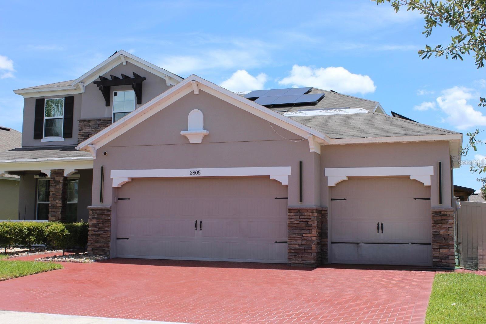 This luxurious 5-bedroom, 3.5-bathroom home has been completely remodeled with high-end finishes and beautiful finishes. It is located in a very family-friendly neighborhood, close to a variety of shops, restaurants, schools, medical centers, and just minutes from Orlando International Airport and Walt Disney World. With numerous upgrades, including a combination of LVT and engineered wood flooring throughout, high ceilings, a security system, high-end lighting, walk-in closets in each bedroom, and a spacious fenced backyard with a pergola and seating area with a fire pit, this home offers ample space for entertaining. The open kitchen features an additional dining area, breakfast bar, granite countertops, tall cabinets, a tile backsplash, and stainless steel appliances. A spacious living room adjoins the kitchen and opens to the backyard. The first-floor master bedroom, with an ensuite bathroom, features dual sinks, a soaking tub, a separate shower, a water closet, and a large walk-in closet. A spacious loft welcomes you at the top of the stairs and leads to the remaining four bedrooms on the second floor. Two bedrooms are connected to a shared bathroom with a tub and shower, separate toilet, and sinks. This home is waiting for you and your family to create unforgettable memories. Best of all, the energy consumption is low thanks to the solar panels and is fully paid for for your enjoyment. Plus, the maintenance fee is low! MOTIVATED SELLER!