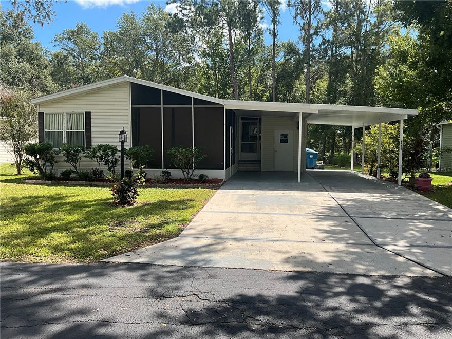 Whether you're looking for a peaceful year-round residence or a cozy winter getaway, this home checks all the boxes.  This beautifully updated and well maintained manufactured home offers the perfect blend of modern comfort and rural charm, nestled in a quiet setting with no backyard neighbors — just wide-open skies and nature as your backdrop, and you own the LOT! NO LOT RENT!  This home has been updated with a contemporary kitchen featuring stainless steel appliances, custom cabinetry, a spacious breakfast bar, granite countertops, and fresh paint throughout.  The home offers new luxury vinyl laminate flooring in most of the rooms, updated bathroom vanities, a spacious sunroom and indoor laundry area for added convenience.  The sunroom offers so much potential, it may be used as an office, study, reading room or just additional living space.   A large covered and screened patio along with a smaller covered screened lanai, and an outdoor storage closet offers outdoor enjoyment and a spot for your gardening tools and accessories.  Enjoy the updated landscaping and serenity of this charming home.   Private driveway and covered carport give plenty of space for a golf cart and for friends and guests to park while visiting.   The community is gated and the gate locks at dusk and can be accessed with the assigned key fob.   The community offers a large community pool, shuffleboard courts and community center and is surrounded by mature trees and manicured landscaping.  Located next door to Rivard Golf course and just minutes from major roadways, local shops, nature parks, and Brooksville’s historic downtown, yet far enough to feel like your own private retreat!