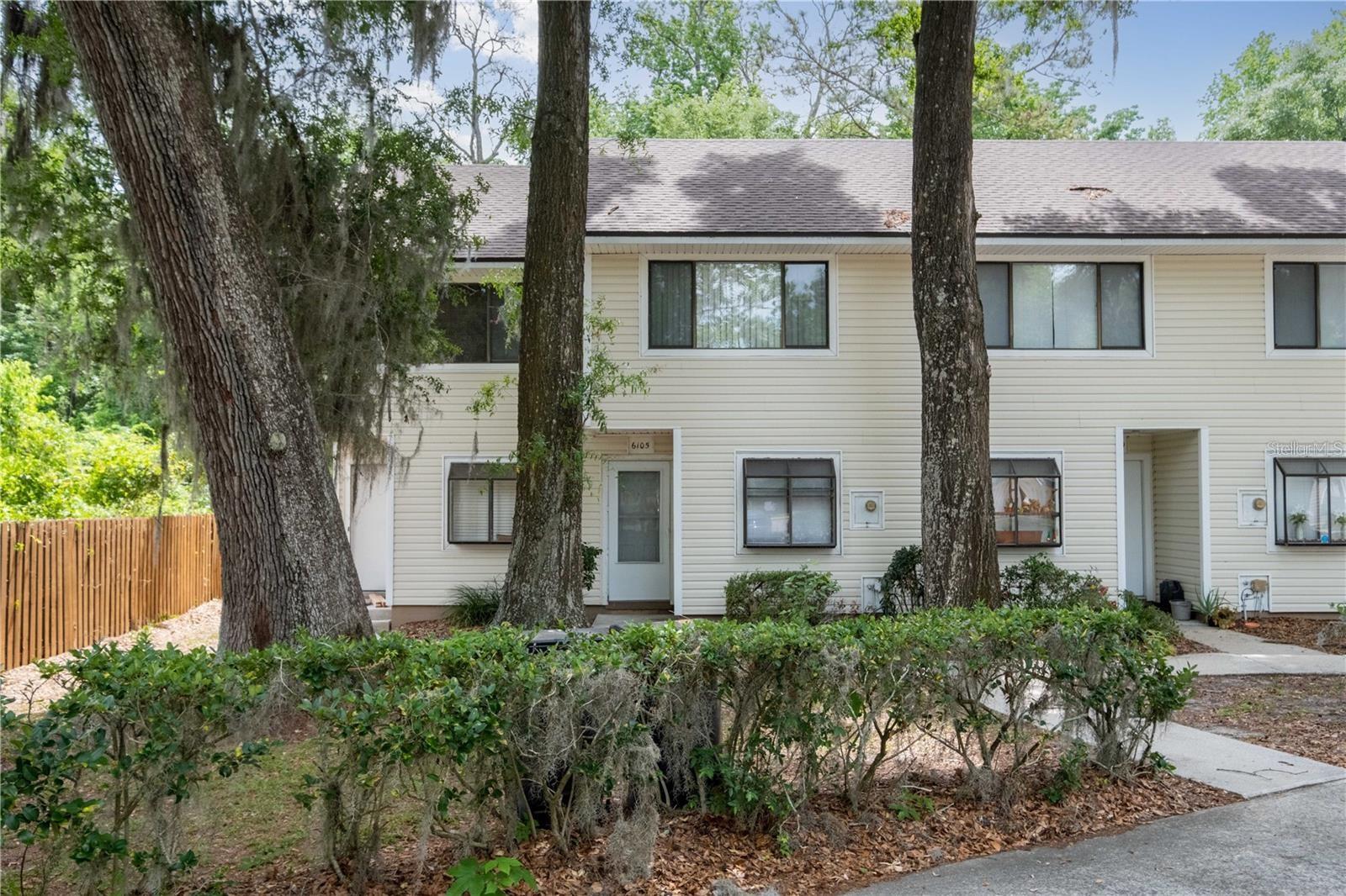 This charming two-bedroom, one-and-a-half-bathroom townhouse in the Shellrock Villas community offers a convenient and comfortable lifestyle. With a prime location close to the Oaks Mall, I-75, North Florida Hospital, and various dining and entertainment options, it is great for primary buyers or investors. The first floor features a well-appointed kitchen, a cozy living room and dining area, a half bath, luxury vinyl plank flooring, and a utility room with a washer and dryer included. Upstairs, both bedrooms and a full bathroom await, with the primary suite boasting walk-in closet. The townhome includes building exterior, garbage service, and lawn maintenance taken care of by the HOA, as well as exterior insurance, including the Roof. Offering you a low-maintenance lifestyle. Additionally, TWO RESERVED parking spots make coming and going a breeze. Schedule a tour today to see this charming townhome for yourself or for investment purposes