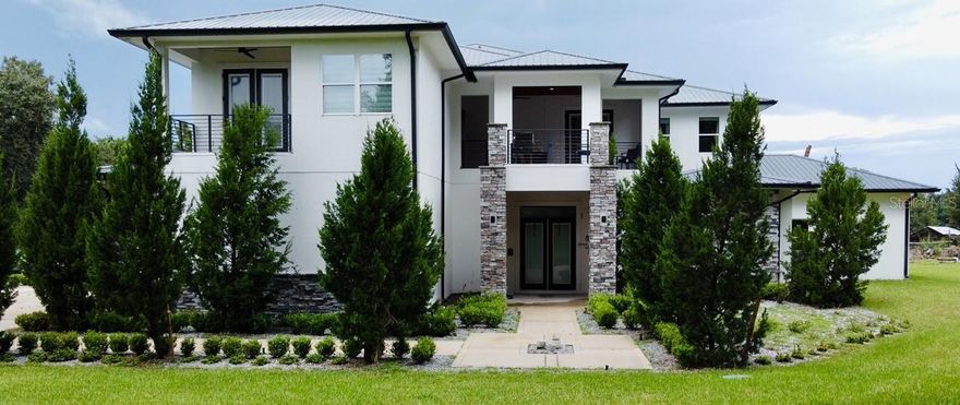 Welcome to this stunning new construction estate situated on just under 5 acres in the heart of Zephyrhills. This 5-bedroom, 4 full bath, 3 half bath home offers the perfect blend of luxury, comfort, and functionality.
Step inside to find a beautifully laid out floor plan with the primary suite conveniently located on the first floor, featuring a spa-like bathroom retreat. The home also includes a versatile bonus office/den, perfect for working from home or creating a private study space part of the.
The heart of the home is the gourmet kitchen, boasting a Wolf range, top-of-the-line appliances, custom cabinetry, and an oversized island designed for both cooking and entertaining.
This home was built with entertaining in mind. Enjoy the dedicated media room with surround sound, an upstairs gaming loft for your enjoyment., and seamless indoor-outdoor living with front and back balconies perfect for watching both sunrise and sunset.
Tech lovers will appreciate the custom whole home speaker system and the all-call intercom system, which allows you to call individual rooms or broadcast throughout the entire home.
Additional features include:
 • Expansive living and dining spaces
 • Bonus office/den
 • Designer finishes and modern upgrades throughout
 • Spacious outdoor areas with endless possibilities
 • Agricultural zoning, so bring your animals
 • Beautifully crafted details in every room
Whether you’re hosting family gatherings, enjoying movie nights, working from home, or relaxing with peaceful views of your land, this home truly has it all.
Location: Conveniently located in Zephyrhills, close to shopping, dining, and easy access to Tampa and Wesley Chapel.
This is more than just a house it’s a lifestyle. Don’t miss your chance to make this luxury estate on acreage your forever home!