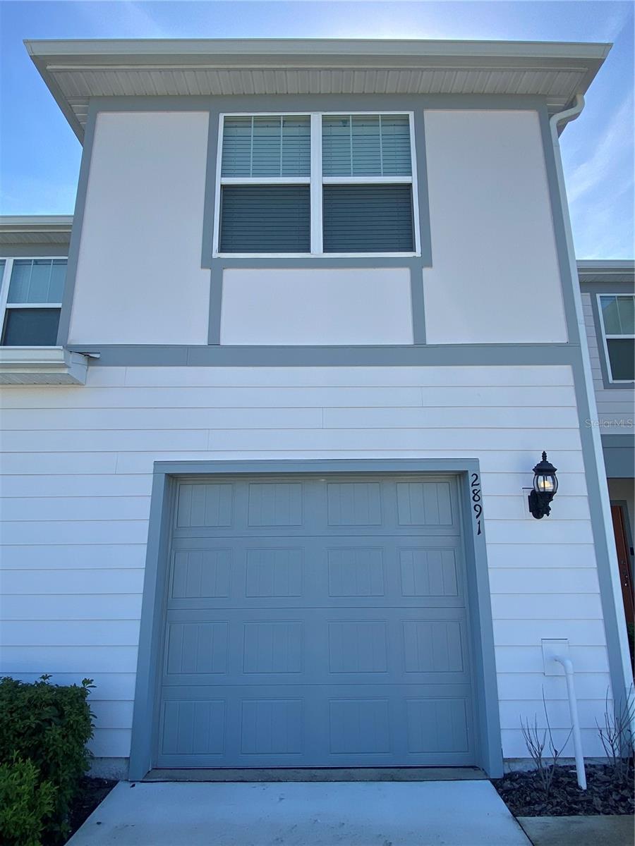 Welcome home to 2891 Clever Lane, a three bedroom, two and a half bath town home with a one car garage! The kitchen overlooks the main living area and features a full suite of stainless steel appliances including the refrigerator, range, over the range microwave and dishwasher as well as plenty of cabinetry and counter top space. The half bath is located on the first floor, easily accessible for guests. Continuing upstairs, the primary bedroom has a walk in closet and private access to the primary bathroom featuring dual sinks, standing glass enclosed shower and separate water closet. Both additional bedrooms are located on the second floor with reach in closets and easy access to the second full bath, which features a shower tub combo. Rounding out this home is the covered rear patio space perfect for enjoying the Florida weather, interior laundry room with full sized washer and dryer included and welcoming community pool!