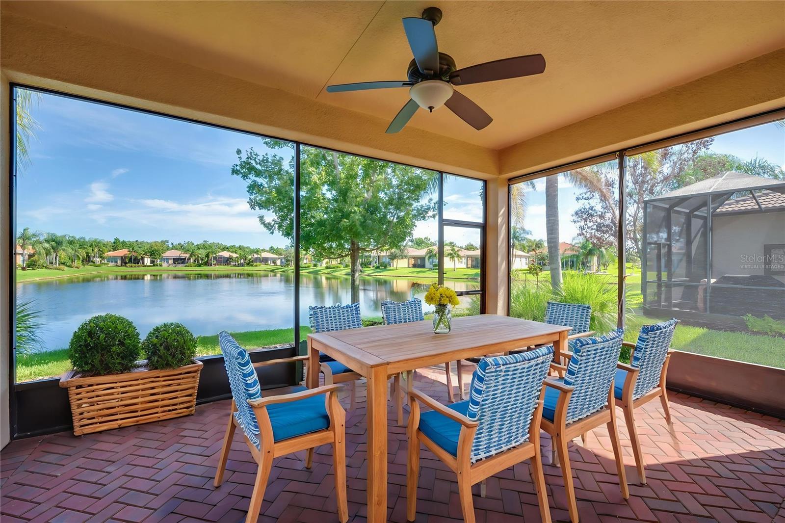 One or more photo(s) has been virtually staged. Welcome to this spectacular move-in-ready home, where elegance meets comfort in one of Tampa Bay’s premier 55+ communities, Valencia Lakes. This stunning Capri model, part of the coveted Signature Collection, offers one of the most sought-after floor plans in the community and showcases breathtaking water views from the moment you step inside. The home’s curb appeal is unmatched, featuring a brick paver driveway and walkway, a beautiful barrel tile roof, and professionally maintained landscaping. Step through the front door and you’ll be greeted by a 12-foot coffered ceiling in the foyer with crown molding, setting the tone for the open and airy design throughout. Large floor tiles, laid diagonally, span the main living areas and the spacious den, which can easily function as a third bedroom and features elegant double glass French doors. The great room is an entertainer’s dream, with triple 8-foot sliding glass doors that lead to a covered, screened lanai offering a peaceful and picturesque water view. Whether you're enjoying your morning coffee or hosting friends, this tranquil outdoor space is sure to become your favorite retreat. The gourmet kitchen is equally impressive, boasting upgraded quartz countertops, an undermount stainless steel sink with an R/O system, 42" soft-close maple cabinets with roll-out shelving, a pantry cabinet, under and over-cabinet lighting, a designer backsplash, and upgraded stainless steel appliances. A charming breakfast bay window floods the space with natural light, while the adjacent informal dining room provides a cozy spot for special meals. Retreat to the primary suite where comfort and luxury blend seamlessly. The bedroom features a coffered ceiling, newly installed plush carpet, and two large walk-in closets with custom built-ins. The en-suite bath is your private oasis, complete with dual vanities topped with quartz, maple cabinetry, a spacious walk-in shower, and a separate Roman tub for soaking. Guests will enjoy their own private space with a generously sized second bedroom and a well-appointed second bath featuring a tub/shower combo, full tile surround, quartz countertop with extended “banjo” top, and maple cabinetry. A separate laundry room adds to the home’s functionality with an upgraded GE front-load washer and dryer, utility sink, and additional cabinetry for storage. Thoughtful upgrades continue throughout the home, including luxury window treatments and plantation shutters, extra recessed lighting, an insulated garage door with epoxy flooring, a water softener system, whole-home surge protector, hurricane shutters, landscape curbing, gutters, a new water heater (2022), a brand-new HVAC system installed in 2024 and more. Valencia Lakes is known for its vibrant lifestyle and top-tier amenities, including a 40,000 square-foot clubhouse, 24-hour fitness center, resort-style pools, on-site bistro, tennis and pickleball courts, bocce ball, dozens of clubs, live entertainment, arts and crafts studios, cooking classes, walking trails, and more. This is not just a home—it’s a lifestyle. Don’t miss the opportunity to make this immaculate, move-in-ready residence your own. Come experience the best of 55+ living at Valencia Lakes today.