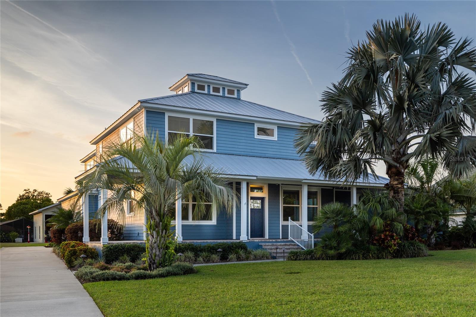 This 2017 custom-built hangar home features 2,807 sq ft of living space, a 1,792 sq ft air-conditioned hangar with a 44'W x 14'H Higher Power hydraulic door (174 mph rated), and a 2-car + golf cart garage. Built with solid block construction and ICYNENE foam insulation, this home includes a Galvalume metal roof, porcelain tile throughout, Bosch & Miele appliances, and a smart layout designed for entertaining. The screened lanai boasts a solar + propane heated saltwater pool, thermal spa, outdoor kitchen, and hurricane-rated enclosure. Whole-house generator (35 kW, 1,000 gal propane), Control4 automation security system, water filter and softener, and Beam central vacuum system. Located in the famous Spruce Creek Fly-In community with a private 4,000' runway, staffed security, parks, Spruce Creek river access, on-site café, optional golf, fitness, and more—all just 7 miles from the beach! Builder's warranty through 2027. Don't miss this exceptional opportunity!