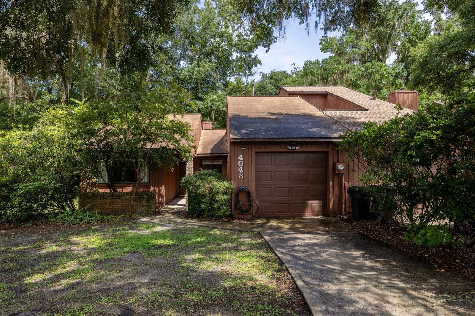 Welcome home to this beautifully remodeled 2-bedroom, 2-bath townhome with a 1-car garage, located in the desirable Cedar Creek community of Gainesville. Step inside to discover luxury vinyl plank flooring, vaulted ceilings, and an open, airy layout that blends comfort with style. The cozy living room features a fireplace and opens seamlessly to a screened-in porch—perfect for enjoying Florida weather year-round. The kitchen offers an easy flow into the dining area, ideal for entertaining or everyday living. The spacious primary suite includes a walk-in closet, a private en-suite bathroom, and sliding glass doors leading to the backyard. A second bedroom, also with a generous walk-in closet, is filled with natural light from windows overlooking the front yard. This move-in-ready home offers low-maintenance living in a quiet, tree-lined neighborhood close to parks, shopping, and the University of Florida. Don't miss your chance to enjoy comfort, convenience, and charm in one of Gainesville’s most established communities!