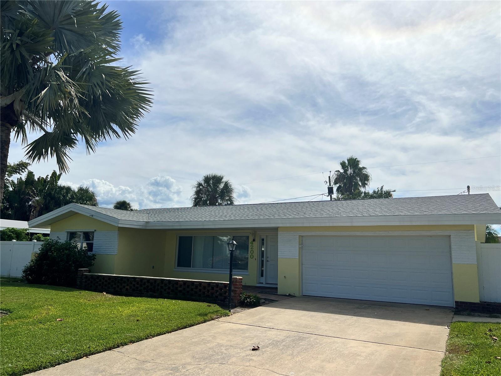 Welcome to this beautiful 3-bedroom, 2-bathroom, 2 car garage home located in the desirable city of St. Petersburg (MAXIMO MOORINGS), FL. This charming house offers a range of amenities that will surely meet your needs. As you step inside, you'll notice the freshly painted interior and new luxury vinyl flooring throughout the main areas, creating a modern and inviting atmosphere. The open floorplan and split bedrooms provide a spacious and functional layout, perfect for any lifestyle. The eat-in kitchen is ideal for enjoying meals with loved ones, and the fenced backyard offers privacy and security for your outdoor activities. Additionally, the huge back sunroom living space provides a versatile area that can be used as a home office, playroom, or entertainment space. The master bedroom boasts an oversized walk-in shower and a double vanity in the master bathroom, offering a luxurious and relaxing retreat. Outside, you'll find lush lawn and landscaping, creating a serene and picturesque setting. The front and back pavered patios are perfect for enjoying the Florida weather and hosting gathering. its convenient location, this home is just minutes away from the beach and a short 10-minute drive to downtown St. Pete, where you can explore a variety of dining, shopping, and entertainment options. Don't miss out on the opportunity to make this house your home. Schedule a showing today and experience the comfort and convenience this property has to offer.