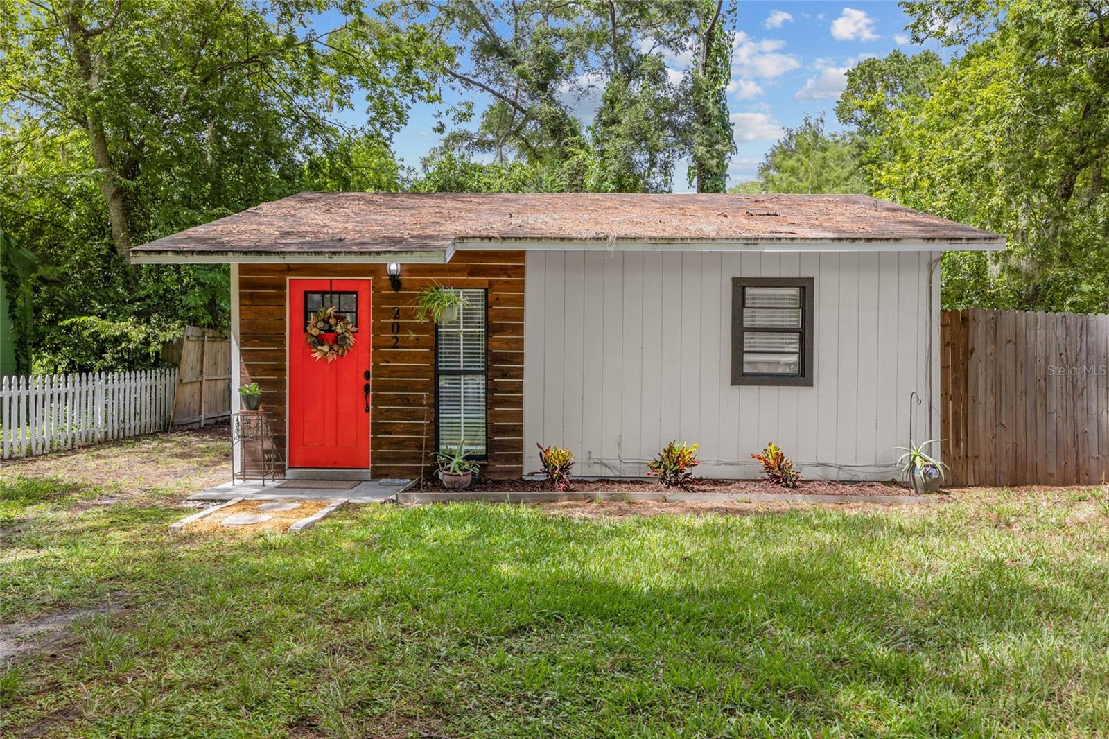 Prepare to be impressed by this compact gem in NW Gainesville! Don't let the 576 sq. ft. fool you. This home feels much bigger than its footprint, thanks to its thoughtful layout and recent updates. Located on a corner lot with a privacy fence, this 2-bed, 1-bath home features gorgeous vinyl plank flooring and a show-stopping kitchen, remodeled in 2022 with a full suite of high-end, matching stainless steel Samsung appliances. The bright living room welcomes you inside and opens to the sleek kitchen. Two good-sized bedrooms and a full bath with a tub/shower combo offer a peaceful escape. Step outside to a small screened porch with convenient laundry hookups. This property offers all the perks of homeownership without the hassle of extensive housework and yard work. It is perfectly situated to enjoy the best of Gainesville, with quick access to UF, lively entertainment, and a variety of great restaurants and shopping. The nearby bus line makes getting around a breeze. Whether you are looking for a starter home, investment, or downsized dwelling, the upgrades, location, and price can’t be beat. Schedule a showing of this small home today before you miss out on this big opportunity!