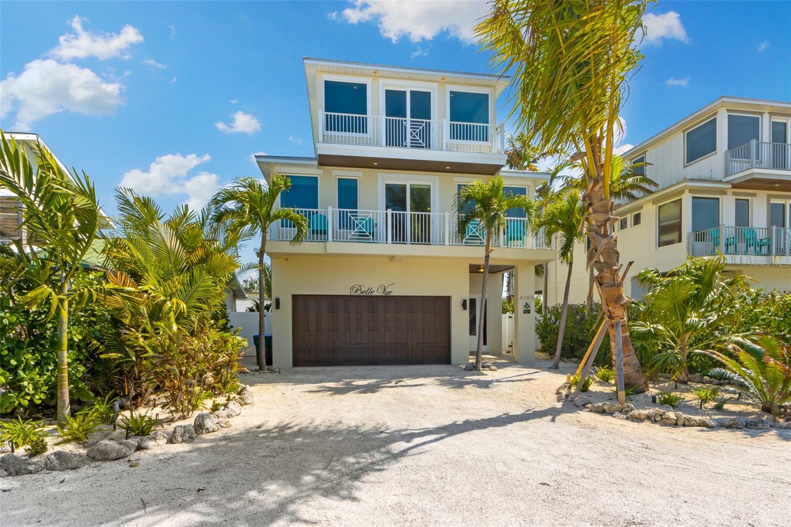 This beautiful 5 bedroom, 4 bathroom home directly across the street from the Gulf of Mexico in Holmes Beach. This GEM just got a refresh with all new landscaping and turf, fresh paint and new interior design. Just steps from the beach with fantastic Gulf views from almost every window, you won't want to miss this! This home is the perfect beach getaway with everything you could want while enjoying Anna Maria Island. Just imagine waking up to the sound of the surf rolling in. Enjoy a cup of coffee or vino on one of your many balconies as the sun comes up and the island comes to life. Spend the day on the beach or take a relaxing dip in your private pool and spa. Practice some putting on your putting green and fresh turf. With plenty of space for entertaining and gathering- the large open concept makes it easy to have everyone over. The bedrooms in this home are beautifully decorated and have plenty of space for everyone. The master bedroom has an en-suite bathroom with a large walk-in closet with the second bathroom on the 3rd floor is shared between the other two bedrooms and has a tub. The second bedroom on the main floor has a private bathroom and the last is shared with the first bedroom and living area. The kitchen has stainless steel appliances and are high end with Thermador appliances and a wine cooler. Fantastic backsplash that looks like waves, all new light fixtures for an updated look. Schedule your private showing today!