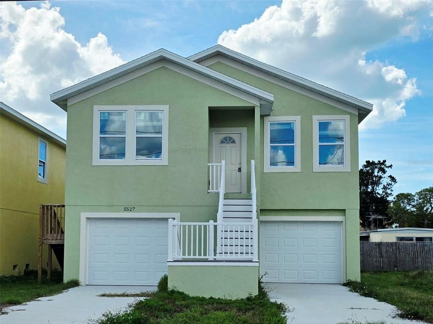 Under Construction. Be among the first to own this brand-new elevated construction home offering modern finishes, additional land, and convenient access to the best of New Port Richey living. This 3 bedroom, 2 full bath home features an open layout and a private primary suite with its own en-suite bathroom. The kitchen offers beautiful quartz countertops, sleek cabinetry, stainless steel appliances, and a wall cabinet pantry, creating a stylish and functional space for everyday living. Entry to the home is via an exterior staircase leading to a covered front porch landing at the main entry. Just off the kitchen sliders is a rear balcony-style porch, providing a private outdoor space to step outside and enjoy the elevated setting. The entire ground level is dedicated to garage parking and storage and features a split under-building garage design with garage bays located on each side of the exterior staircase, allowing space for multiple vehicles, storage, or workshop use. The property includes a second lot, bringing the total parcel size to approximately 0.16 acres, with the additional lot designated for the septic system, which is scheduled to be installed in the coming weeks as construction nears completion. Located in a convenient area close to shopping centers, local restaurants, parks, and everyday amenities, with easy access to Historic Downtown New Port Richey, known for its riverfront parks, dining, community events, and charming local shops. The area is golf cart-friendly and offers a relaxed coastal lifestyle with nearby public beaches and waterfront parks just a short drive away, making this a great opportunity to own a newly constructed home in a growing area that offers both convenience and coastal charm.