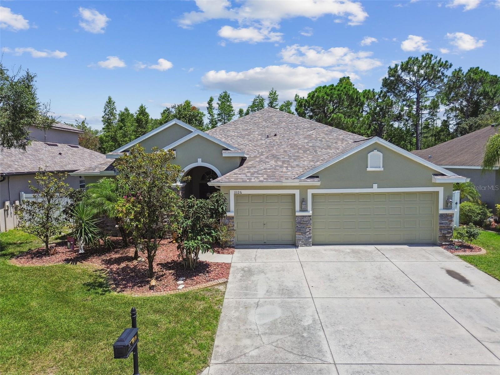 Welcome to Waters Edge – where luxury meets lifestyle! This beautifully upgraded 4-bedroom, 3-bath pool home with 3-car garage sits at the end of a quiet cul-de-sac, offering exceptional privacy, preserve views, and curb appeal. Enjoy peace of mind with a brand-new roof and updated mechanicals. Inside, soaring ceilings and a split-bedroom layout highlight the spacious primary suite with dual walk-in closets, spa-style bath, and direct access to the screened pool and spa. The open-concept kitchen features stainless steel appliances, a breakfast bar, and clear sightlines to the oversized family room and pool. Additional features include a formal living room, upstairs bonus room (bedroom 5), dedicated pool bath, and a huge storage closet. Relax outdoors under the covered lanai with paver patio, hot tub, and tranquil backdrop of no rear neighbors. Enjoy resort-style amenities in the gated Waters Edge community—clubhouse, fitness center, basketball/pickleball courts, playgrounds, fishing pier, dog park, scenic trails, and a water park-style pool with splash pad and spa. Plus, 24-hour security and manicured common areas. This home checks all the boxes—schedule your private tour today! (ROOF-2025)(A/C-downstairs-2023/upstairs-2007)(W/H-2017)