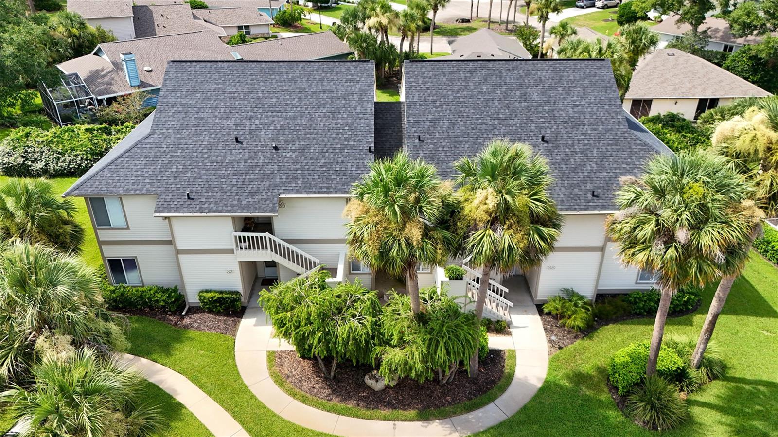 Premium condo with beautiful renovations and ready for new owner! This 2 bedroom, 2 bath, 2nd floor condo has wrap around porch and an open floor plan. Once you enter the property, you are greeted with a large family room with double sliders, all opening out to the screened lanai. High ceilings and luxury plank vinyl floors finish out the family room. Completely redone kitchen with 42in wood dovetail/soft-close cabinets, Granite Countertops, TILE backsplash, STAINLESS STEEL appliances, and kitchen window. Paired with dining room with LVP flooring, large window, and new chandelier. Walk into your first suite which is Master Bedroom with LVP flooring, 2 closets, sliders out to the lanai, and en-suite bath. Master bath has TILE tub/shower combo and new vanity. 2nd Bedroom is also large in size with LVP flooring, sliders out to lanai, and door to connecting bath. 2nd Bath is set up as Jack and Jill concept with WALK-IN tile shower, new vanity and door for guests. Enjoy the beautiful weather with wrap around screened porch with new ceiling fans and freshly finished wood flooring. Assigned covered parking spot and full washer/dryer closet in unit. Magnolia condos are located right on the golf course with easy walking distance to all the amenities within Plantation Bay. These units are completely maintenance free and beautiful grounds for walking. All located in GATED, golf cart friendly community with optional Country Club membership. Membership to include 45 holes of golf, tennis, pickle ball, bocce ball, 2 clubhouses, 2 community pools and cabana. Seller is also willing to rent the unit on a 6- or 12-month term. Ask listing agent for details.