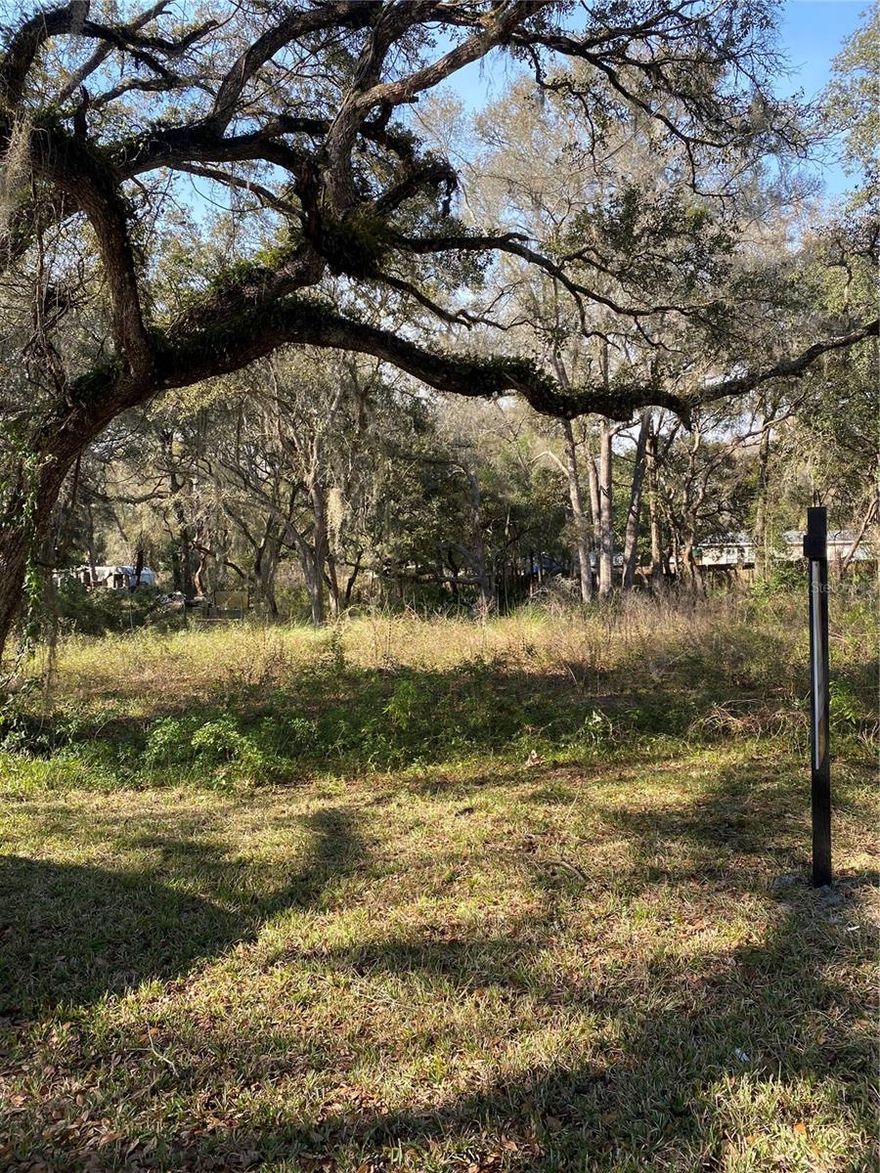 Welcome to your serene oasis nestled amidst picturesque trees, beckoning you to place your mobile home. This stunning lot, conveniently located just 10 minutes from I-75, offers the perfect blend of accessibility and tranquility. Situated on a paved street, it welcomes both mobile and site-built homes, promising a seamless transition into your ideal living space. Immerse yourself in the beauty of nature as you explore the lush surroundings adorned with majestic trees, creating a serene backdrop for your new abode. With a mere 40-minute drive to Tampa, you'll have easy access to city amenities while enjoying the peaceful ambiance of rural living. Discover solace just 5 minutes away at the Florida National Cemetery, honoring those who served with dignity and respect. Additionally, the convenience of being only 10 minutes from town ensures effortless access to everyday essentials and community offerings. Escape the hustle and bustle of urban life while still being within reach - just 40 minutes from Ocala, offering endless possibilities for adventure and exploration. Whether you're seeking a tranquil retreat or a gateway to nearby attractions, this remarkable lot invites you to craft a lifestyle of comfort and convenience amidst nature's embrace.