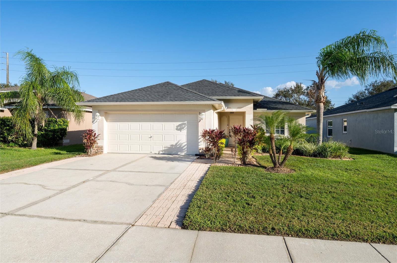 Nestled within the serene subdivision of Chapel Pines in Wesley Chapel, this impeccably maintained 4-bedroom, 2-bathroom residence with a 2-car garage offers a harmonious blend of elegance and comfort. The home is set against a picturesque conservation land, adorned with majesticoak and pine trees, ensuring both tranquility and privacy. As you enter, you are greeted by a refreshing ambiance of design and care throughout.The spacious living and dining areas connect to an updated kitchen, featuring stainless-steel appliances. Elegant tile flooring enhances the socialareas, while the bedrooms are adorned with newly installed neutral color carpeting. The kitchen shows modern farm house stainless-steel sink, anew dishwasher, and an upgraded stove, perfect for both casual meals and entertaining. From the inviting family room, step out onto theexpansive Florida Room, surrounded by vibrant flora, creating a private oasis for relaxation for the whole family. The master suite, thoughtfullypositioned at the rear of the home, offers serene views of the patio and is bathed in natural light. The spacious master bathroom features a dual-sink vanity, a garden tub, and a walk-in closet, catering to both style and functionality. Custom-made window treatments grace every window,adding a touch of sophistication to each room. Significant updates include a new roof (2020), gutters (2015), oversized A/C unit, and an electricwater heater (both replaced in 2015), along with a new garbage disposal installed last year. Conveniently located near top-rated schools, andjust moments away from Walmart Supercenter, Wiregrass Mall, Tampa Outlets, and a selection of world-class dining options, this home offerseasy access to I-75 and other major highways. Discover the charm and elegance of this exceptional house—schedule your visit today!