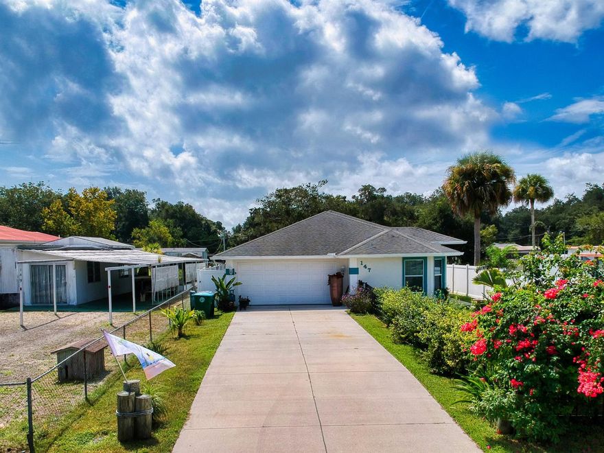 Waterfront home situated on a nice size lot overlooking a deep canal that offers access to the Intracoastal Waterways of the Indian River. This water-lovers dream home boasts a 48; sea wall, large concrete boat dock w/lift and tiedowns making it ideal for fishing, watersports or just relaxing. Inside this well maintained home, vaulted ceilings combine with large rooms and beautiful 18’ tile flooring to create a bright and cheerful living space throughout most of its open floor plan.  A well-appointed kitchen sits in the heart of this home offering an easy to work in floor plan, ample counter space and a large pantry for additional storage all overlooking an expansive breakfast bar and the living area.  Its spacious Owners Suite features 2 large closets and a cozy sitting area that could be ideal for use as an office, workout area or just a relaxing nook and made complete with a luxurious bath complete with double sink, walk in shower separate water closet and an oversized tub.  French Door from the living room provide access to the massive, enclosed patio room that spans the length of the home and boasts panoramic views of the canal. Other features of this home include, inside laundry, outdoor shower, oversized 2 car garage coated with Apoxsee floor coating and its newly fenced yard provides room for a pool or to expand its outdoor living areas to enjoy watching the manatee and dolphins play right outside your door. ;Water: City