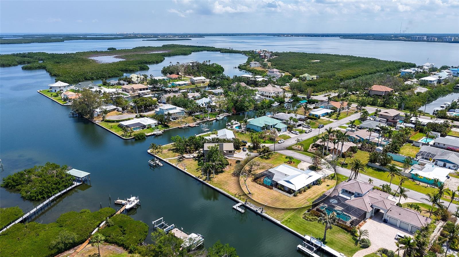 One or more photo(s) has been virtually staged. Snead Island Waterfront Oasis Awaits Your Finishing Touches – A Nature Lover’s Dream! Welcome to your slice of paradise on iconic Snead Island! This classic 4BR/2BA ranch home sits on nearly a half-acre waterfront lot with 130 feet of seawall and a private dock, perfect for the boating enthusiast. Enjoy peaceful mornings and stunning sunsets from your oversized, screened in lanai (new screens 2025) with covered seating and a sparkling pool overlooking panoramic water views where fish jump and birds soar. The home features a newer metal roof (2019), brand-new high-efficiency HVAC (2024), hurricane shutters (automatic & manual), circular driveway, and an oversized 2-car garage. Inside, the flexible layout includes a 4th bedroom that can double as a den or office. Nature lovers will appreciate being just a short bike ride to Emerson Point Preserve, a 365-acre nature preserve full of native plants and wildlife with miles of scenic hiking and biking trails, many kayak launches, the J.J. "Toby" Holland educational center, and breathtaking views from several observation towers. After a day of adventure, cool off at the Bradenton Yacht Club, offering fine dining and vibrant social events. Snead Island is perfectly positioned at the mouth of the Manatee River and Tampa Bay with multiple marinas, dry storage options, and public boat launches nearby giving you quick access by boat to the beaches, Egmont Key, Ft. Desoto Park, endless fishing, waterfront dining and aquatic fun. Don't miss your chance to own a slice of paradise on sought-after Snead Island with an ideal canvas for your waterfront lifestyle vision!
