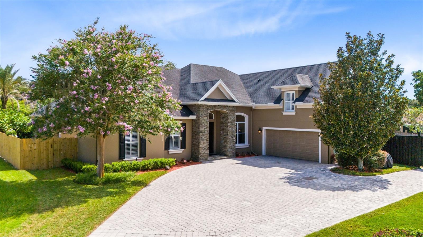 MUST SEE – Unique Custom Home. Welcome to a private oasis in the heart of Conway. This estate is tucked away in a quiet GATED community with only 12 custom homes and top-rated schools! This custom pool home offers 5 bedrooms and 4 bathrooms with a split floor plan that ensures privacy for everyone. The spacious paver driveway leads to a two-car garage with mature landscaping and decorative slate stones surrounding the beautiful front doors. Once inside, the grand foyer welcomes you with soaring 14-foot ceilings and abundant natural light. The open-concept kitchen/family room layout is designed for both comfort and style. Additional highlights include tray and coffered ceilings, crown molding, a large stone fireplace, expansive windows, and French doors that open to a backyard oasis, complete with a custom pool and waterfall. Tucked off the living room is your primary suite. The expansive bedroom leads into a spa-like bathroom, with double vanities, a soaking tub, and a large, enclosed shower. In addition to the designated office/flex room and three spacious bedrooms and two bathrooms, the fifth upstairs bedroom is newly renovated with an en suite bathroom.
The backyard paradise is ideal for entertaining with a stunning pool/waterfall feature, tropical landscaping, covered lanai, and pergola/seating area.
Another highlight is a detached storage building and enclosed parking area suitable for recreational vehicles. This home is centrally located and will not last long. Schedule your private tour today!