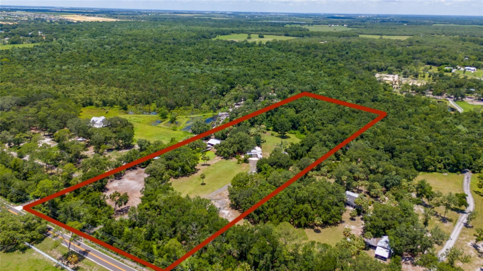 Escape to your own 10-acre oasis! This beautifully maintained property features a 3-bed, 4-bath home with a bonus room, spacious kitchen with large island, and open-concept living/dining area with authentic Mexican tile. Enjoy outdoor living with a private pond, shaded ATV trails, horse paths, and a BBQ area perfect for gatherings. The property includes a massive shop with conversion potential and an oversized barn ideal for equipment, toys, or animals. Unique custom details throughout, including a one-of-a-kind wood countertop made from a tree on-site. Just 18 mins to Legoland, 48 mins to Disney Springs, under 1 hour to Disney & Universal, 2 mins to Cherry Pocket Steak & Seafood, one of the most iconic restaurants in the area located across the street in Lake Pierce and 37 mins to River Ranch. Enjoy country living with city attractions nearby—this one has it all!