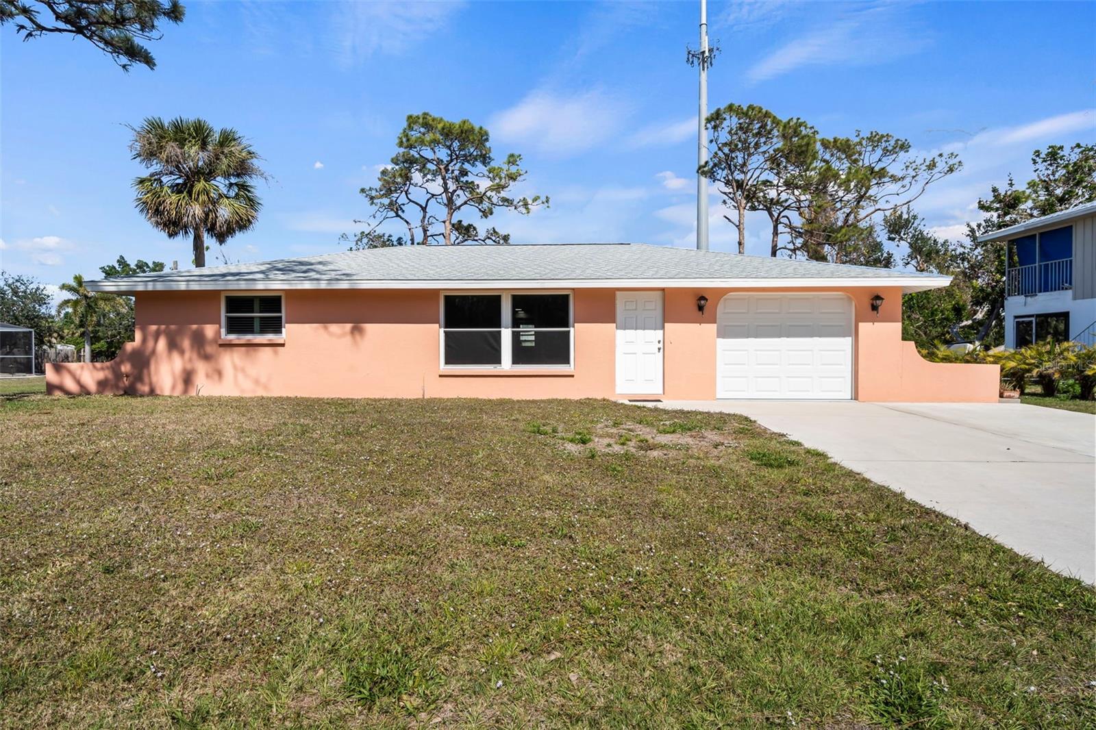 Just reduced $20,000. This fully remodeled, move-in ready home is located west of The Trail in Nokomis, offering a great opportunity to experience casual coastal living in a vibrant community without HOA fees. Just a short walk, bike ride, or golf cart trip away from Nokomis Beach, boat ramp, fishing, kayak launch, shopping, dining, Sunsets and four tiki bars with live entertainment, plus much more! The oversized 14,000+ square foot lot has no deed restrictions, so you can park your RV, boat, or any of your toys with ease. The home has been upgraded from top to bottom, including a brand-new roof, an upgraded electrical panel, and IMPACT GLASS. Inside, you'll find new luxury vinyl flooring throughout, a modern kitchen featuring soft-close Shaker-style cabinetry, granite countertops, and all-new Whirlpool appliances, including a built-in microwave hood. Both bedrooms are equipped with plantation shutters, and the upgraded bathroom boasts granite, soft-close cabinets, and an upgraded toilet. A large laundry room is conveniently located off the garage, which also is an opportunity to add a second bathroom, and oversized one-car space with epoxy floor paint. Enjoy carefree days in the warm Florida sunshine, making this home the perfect get-away alternative to a condo with more privacy and no fees. This home would also make a great investment with plenty of opportunities to be a seasonal rental when not being used by the owner.