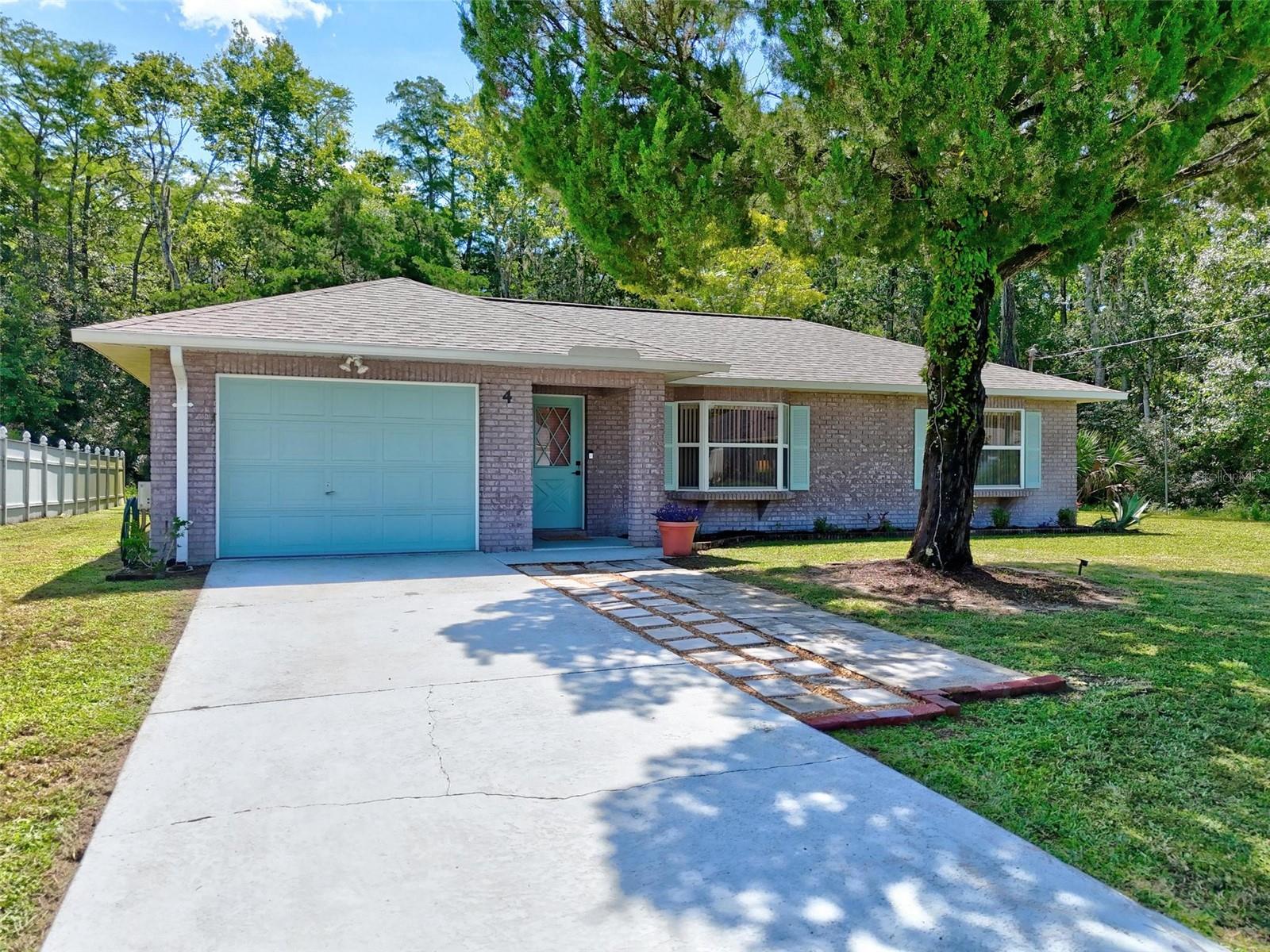 Welcome to this charming 2-bedroom, 2-bath home nestled on a cul-de-sac in the desirable Quail Hollow neighborhood of Palm Coast. Cute as a button and full of character, this well-maintained BLOCK construction home is located in an X FLOOD ZONE—no flood insurance required! Recent updates include a newer roof (2022), a screened-in lanai, a detached storage shed, and a dedicated dog run, all surrounded by gorgeous mature landscaping. The Kitchen sink window overlooks the backyard, perfect for watching the dogs or kids play! Hurricane shutters come with the home, providing extra security and peace of mind! Beautiful bay windows at the front of the home fill the space with natural light. Just 10 minutes to the beach and close enough to shopping, dining, and parks that you can WALK or BIKE. Whether you're a first-time buyer, seasonal resident, or investor, this property offers the perfect blend of comfort, location, and value.