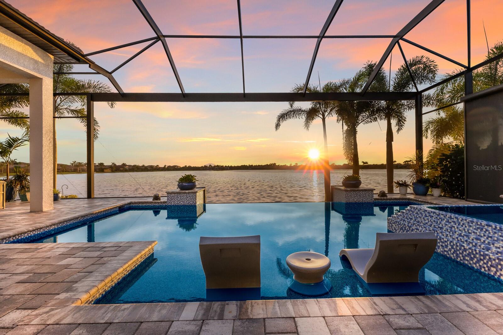 This 3,700 sq. ft. lakefront stunner delivers a 10/10 on every detail—floor plan, outdoor space, view, and those million-dollar sunsets. Featuring 3 bedrooms, 3 baths, an office, bonus room, oversized 3-car garage, and upgrades galore—plantation shutters, outdoor kitchen, motorized awning, custom closets, smart house features, and more. Enjoy breathtaking sunsets from your lanai, complete with firepit table and space for grilling, dining, and relaxing. Located in Toscana Isles, a resort-style community with tennis, pickleball, pool, fitness center, and endless amenities—just minutes to beaches, shopping, dining, and I-75. Built like a fortress, this home blends elegance, comfort, and peace of mind. Call for a private showing.