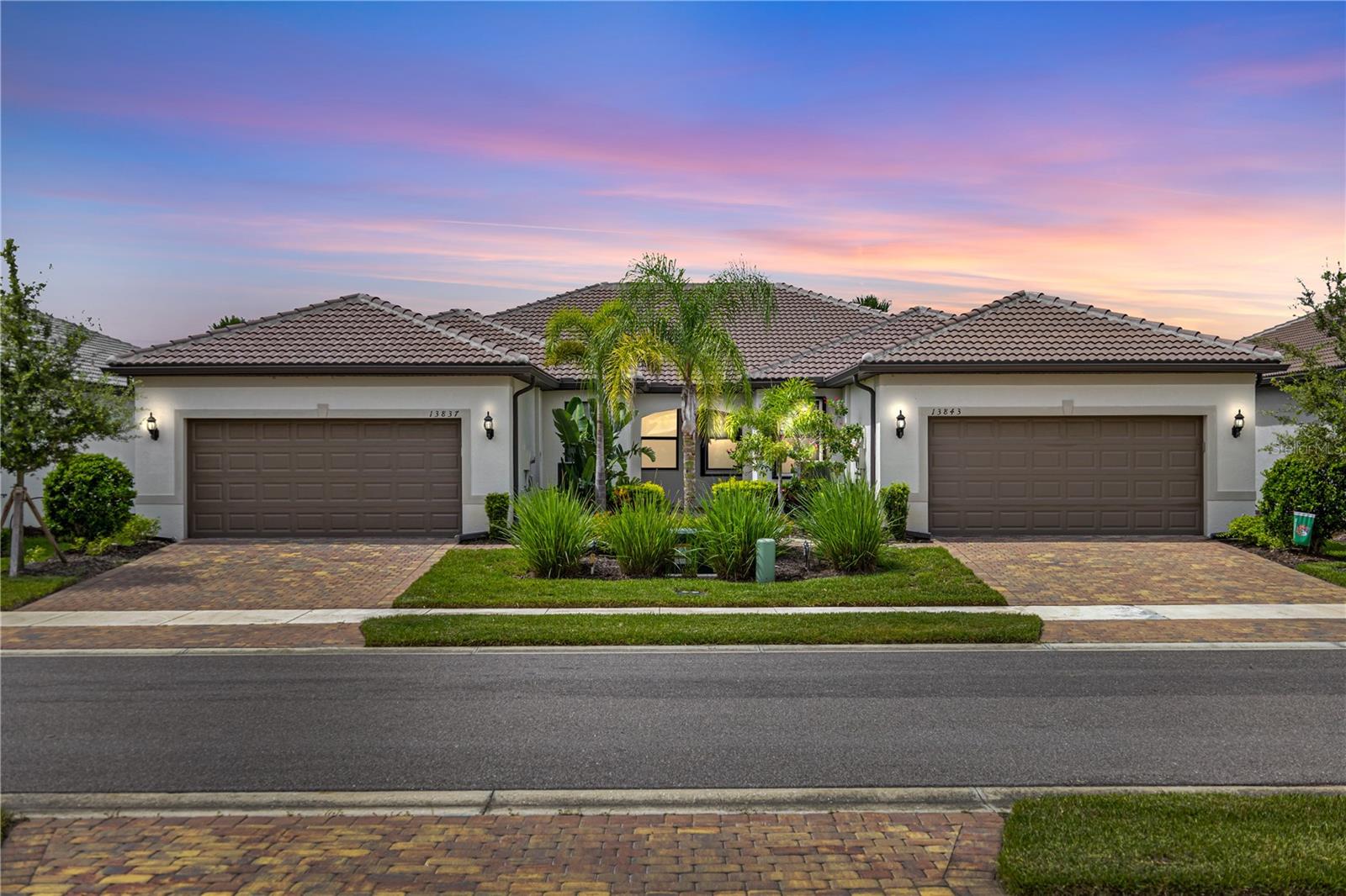 Welcome to IslandWalk at the West Villages, where every day feels like a vacation in this stunning resort-style, 24/7 manned gated community. Built in 2022, this Mediterranean-style Cascadia Villa offers captivating curb appeal with its barrel tile roof, pavered driveway and walkway, lush tropical landscaping, and tranquil lake views. Offering over 1,600 square feet of beautifully designed living space, this villa includes 2 bedrooms, 2 bathrooms, plus a versatile office/flex room. Step inside to find an open concept layout with top of the line wood-look wide plank, extra long tile flooring flowing throughout the main living areas, fixtures from Venice Lighting, 8-foot doors, and custom blinds and window treatments that elevate the style and comfort of the home. The kitchen is a showstopper with upgraded white cabinetry, quartz countertops, a striking glass tile backsplash, and stainless steel appliances. A spacious breakfast bar provides plenty of seating and seamlessly connects to the dining and living areas, making entertaining effortless. The split bedroom layout provides added privacy, while the owner’s suite feels like a serene retreat with dual closets professionally upgraded with extra storage and built-ins, and a spa-like en-suite bath featuring dual sinks, an oversized frameless walk-in shower with built-in bench, and upgraded cabinetry. Additional features include a dedicated laundry room with storage, built-in speaker system, upgraded 5+ inch baseboards, grounded electrical panel for surge protection, and an insulated attic with pull-down ladder and added storage space. The garage has been thoughtfully upgraded with lifetime flooring, built-in storage closets, and a gardener’s sink. Step outside to your oversized pavered lanai with a privacy wall and peaceful waterfront views—your own private oasis for relaxing or entertaining. IslandWalk is known for its vibrant, active lifestyle with world-class amenities including multiple resort and lap pools, two fitness centers, 12 pickleball courts, har-tru tennis courts, bocce ball, community garden, covered dining area with BBQ grills, fire pits, basketball, a dog park, playground, and a clubhouse with a full-time Lifestyle Director. HOA fees cover lawn care, tree trimming, mulch, high-speed internet, basic cable with DVRs, and on-site management, providing incredible value. Located near the exciting new Wellen Park Downtown and surrounded by lakes, preserves, and Gulf Coast beaches—this is Florida living at its finest. Don’t miss your chance to call this incredible home yours—schedule your private tour today!