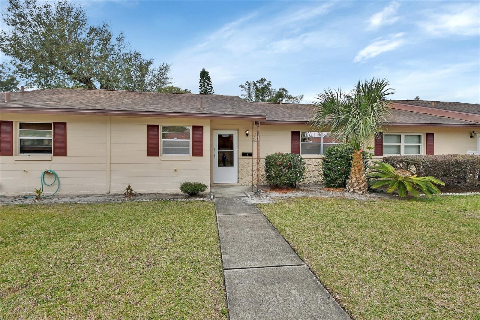 ATTENTION!! MAJOR PRICE ADJUSTMENT!! SELLER MOTIVATED and has reduced the price for immediate sale! Within walking distance to the only U.S. town to hold both the Great American and America’s Main Street titles. Downtown DeLand features restaurants, boutique shopping, banking and churches at your fingertips. This is the most affordable condo in this 55+ community. Monthly condo fees includes water, sewer, garbage, exterior of the building, grounds maintenance, insurance on the building plus reserves. Primary bedroom has 2 closets plus ensuite. Plenty of storage with two additional closets in the hallway between the 2 bedrooms. Nice Florida room that opens to a screened lanai plus convenient inside laundry room. Small complex where you will know your neighbors. Easy commute to Earl Brown Park where you can enjoy strolling around the pond, listening to concerts, tennis and the newest craze of pickleball. Stetson University Baseball and Football games are at your fingertips and if you enjoy the theater then you are only minutes away from the Athens Theater. Get away from the snow and enjoy your winters in delightful DeLand.