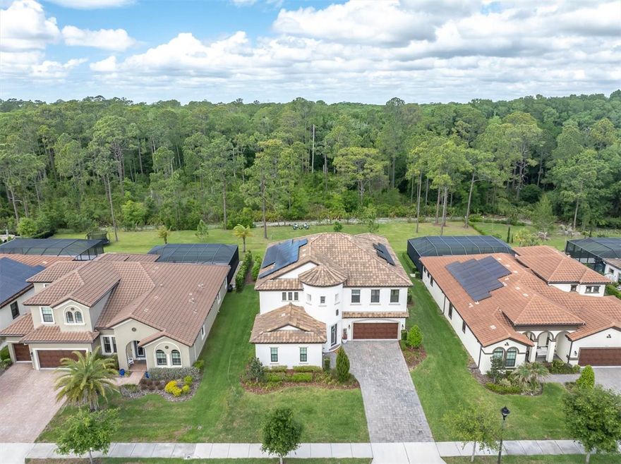 Welcome to a luxury estate in the coveted gated section of Anclote Reserve At Starkey Ranch a Tampa Bay award winning master planned community. This exceptional Madeira III by WestBay Homes sits on one of the few expanded homesites in the entire community — an impressive .40-acre cleared lot backing directly to the serene Starkey Wilderness Preserve, offering unmatched privacy and breathtaking natural views.
This expansive residence offers 5 bedrooms, 3.5 bathrooms, and over 4,200 square feet of living space, blending luxury, functionality, and energy efficiency. The home features a fully paid-in-full solar system with 104% power offset using REC panels valued at approximately $60,000 — delivering the rare benefit of virtually no electric bill.
Step into your private resort-style backyard oasis designed for ultimate relaxation and entertaining. Enjoy a saltwater pool and heated spa powered by a 400K Pentair heater with seven jets and a tranquil water feature. The outdoor space is finished with beautiful travertine decking, landscape rock accents, gutters in the backyard and over the pool equipment area, and a premium Canadian Timber Collection cedar sauna featuring a 7-kilowatt Harvia heater, hardwired to electric and designed to accommodate up to eight people, valued at approximately $20,000.
Inside, you are welcomed by grand two-story ceilings, elegant crown molding in the foyer, tray ceilings, and designer lighting throughout the main living areas, including custom fixtures from Pottery Barn. The living room features a custom stone accent wall, built-in ceiling speakers, and remote-controlled custom window shades, creating both comfort and sophistication.
The gourmet kitchen is a showpiece, featuring quartz countertops with extended seating, tiled backsplash, extended cabinetry with glass showcase display, gold hardware and faucets, reverse osmosis system, and a spacious layout perfect for entertaining. The thoughtfully designed floor plan includes a first-floor bedroom with a private full bath, ideal for guests, in-law quarters, or a secondary owner’s suite, along with a den or office with glass double doors and a beautifully designed drop zone with tile flooring for everyday convenience.
Additional upgrades throughout the home include a water softener system, tankless water heater, CAT 6 internet pre-wiring, three 3-ton AC units, custom rods, curtains, and shades that convey, and a spacious laundry room complete with folding table and built-in drawers. Upstairs, the home features a Jack-and-Jill bathroom and generous secondary bedrooms, while the luxurious owner’s retreat showcases crown molding, black quartz countertops with gold accents, and a large garden soaking tub creating a spa-like atmosphere.
The backyard is thoughtfully designed with cleared land maximizing space while maintaining the natural beauty of the preserve setting. This rare estate offers luxury finishes, energy efficiency, resort-style outdoor living, and one of the largest homesites in Starkey Ranch — all within a private gated enclave. Experience elevated Florida living at its finest.
The community includes multiple parks, playgrounds, pools, kids splash zone, magnet K-8 elementary middle school, county library, starkey ranch district park,tennis, and over 20 miles of walking/biking trails. Conveniences include grocery, restaurants,nails and hair salon and a neighborhood favorite starkey market.