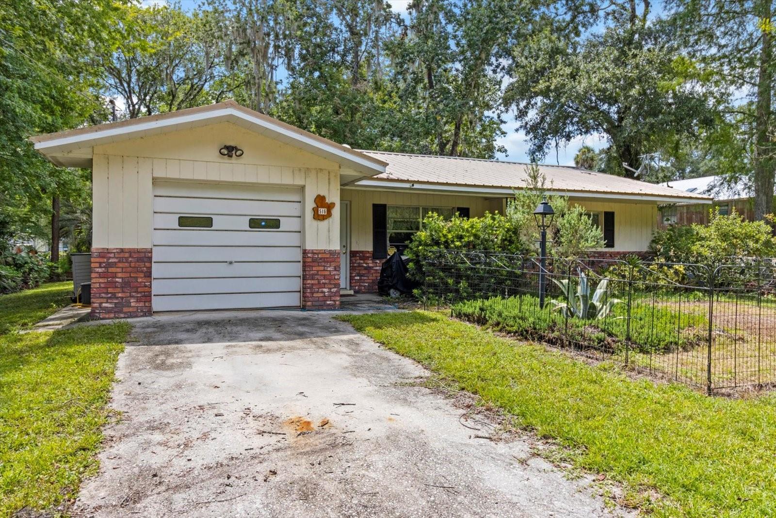 Welcome to your peaceful retreat in the heart of Sherwood Forest! Enjoy the perfect blend of charm, comfort, and convenience.
This well-maintained, FURNISHED 2-bedroom, 1-bathroom home offers 1,076 sq ft of living space on a generous 0.35-acre lot with 93 feet of WATERFRONT along a tranquil river canal on the Withlacoochee River—great for kayaking, fishing, or simply enjoying the peaceful views.
Built in 1973, the home has been lovingly maintained and thoughtfully updated. A metal roof installed in 2014 and a new HVAC system from 2017 mean you can move in worry-free. Inside, the home features ceramic tile flooring throughout, giving it a clean and cohesive look. The kitchen is bright and functional, with wood cabinetry, laminate countertops, a breakfast bar, and a skylight that fills the space with natural light. Appliances include a gas range, microwave, dishwasher, refrigerator, and a water filter system.
The washer and dryer are located in the garage, keeping your living space quiet and clutter-free. The open layout is cozy and practical, with a warm, inviting atmosphere that makes you feel right at home. From the dining room, sliding glass doors lead to a 25' x 10' screened patio, great for enjoying the outdoors without the bugs. Step out from the screened area onto the 30' x 10' covered rear porch, which offers plenty of space to relax, entertain, or park your boat or lawn equipment.
A sidewalk runs from the driveway along the side of the house, leading directly to the rear covered porch—making it easy to access the backyard and canal without walking through the home. At the front, a covered walkway porch connects the driveway to the front door, offering a welcoming entrance and protection from the elements.
Additional features include a 1-car attached garage, concrete driveway, storage closet on rear porch, and mature landscaping that adds privacy and curb appeal. Enjoy the quiet of a dead-end paved road and no HOA. Utilities are private well and septic, keeping monthly costs low.
Come enjoy all Inverness has to offer. Bike, Jog or Walk the Withlacoochee State Trail, Liberty Park, The Depot, Restaurants, Shops, Courthouse Square, Boating, Fishing, The Tsala Apopka Chain of Lakes, Churches, Parades, Valerie Theatre Culture Center, and City Festivals.
Conveniently Located Near:
Downtown Inverness – 2.5 miles (6 min)
Citrus Memorial Hospital – 2.7 miles
Whispering Pines Park – 3.2 miles
Shopping – 3.5 miles
Inverness Middle & High Schools – 3.8 miles
Withlacoochee State Trail – 2.2 miles
Tampa VA Hospital – 1 hr 12 min
Gainesville VA Hospital – 1 hr 6 min
Tampa Airport – 1 hr 18 min
Orlando Airport – 1 hr 6 min
World Equestrian Center – 51 min
Whether you're looking for a full-time residence or a weekend getaway, this home offers a rare opportunity to enjoy Florida living with direct river access, natural beauty, and small-town charm.