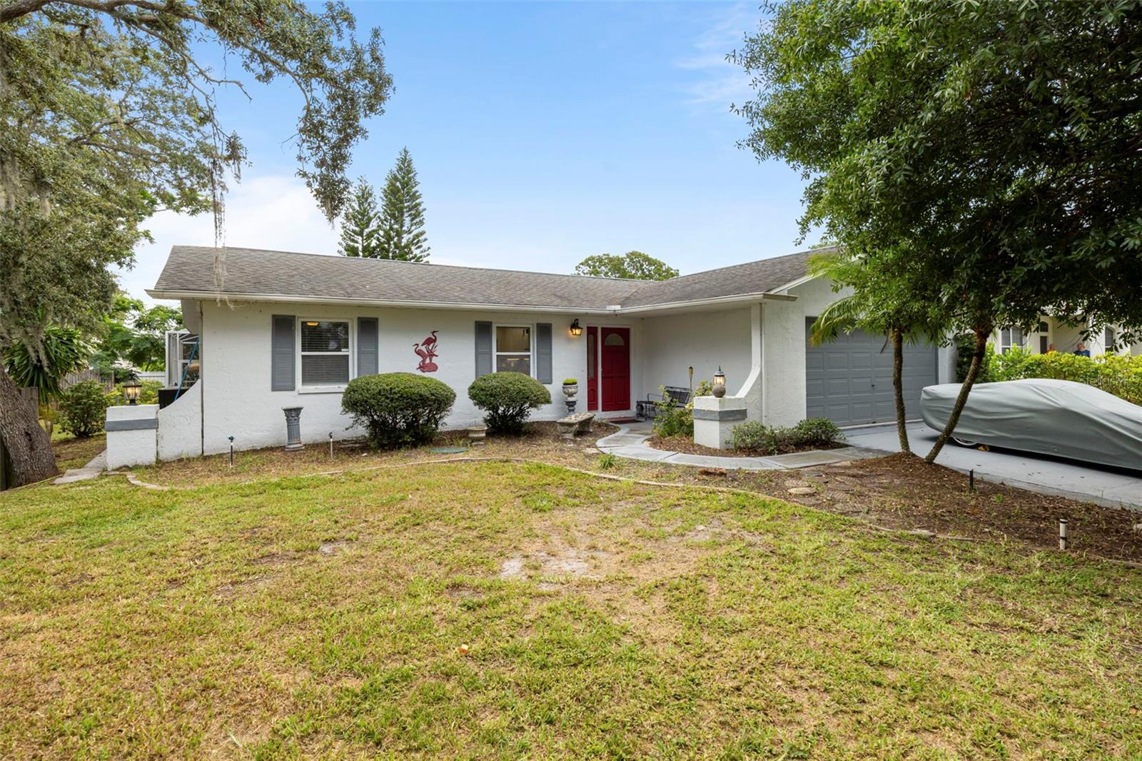 Are you looking for a great home in a fantastic location situated on one of the largest lots in the immediate neighborhood? Pride of ownership shines through on this meticulously maintained 3 split bedroom plan, 2 full bath, 2 car garage, salt water pool home, in the heart of Tarpon Springs! As you step into this home you are greeted by a gorgeous updated open concept kitchen and dinning area to include an island for easy entertaining. Stainless steel appliances, quartz countertops and glass tile backsplash for easy maintenance. LVP flooring throughout home with tile in bathrooms. Outdoors boasts more space than you can imagine with an outbuilding that has electricity and insulation to make a studio, storage or your private retreat surrounded by native plants that include palms and lemon, lime, orange and plantain fruit trees. You can relax in the newly renovated and inviting screened birdcage-enclosed saltwater pool for a refreshing, low-maintenance swimming experience and heater as well for the very rare cold Florida days if necessary. Park your boat or RV ( additional separate 50 amp plug) outside with plenty of room for other activities; Why? this home sits on nearly 3 city lots at the dead end of the street; that's almost half an acre (0.45 acres) of privacy!!! There is still plenty of space to add an additional garage, maybe a small studio to rent out - it is a blank canvas for your imagination and design! Enjoy the vibrant local culture with nearby attractions, offering waterside dining and shopping, as well as annual art shows and a quaint downtown area... This home offers easy access to sun, sand, and sea ideally situated for all sorts of entertainment and lifestyle activities at your fingertips! In mere minutes visit Fred Howard State Park & Beach (0.7 mile/5 minutes), Sunset Beach (1.5 mile/7 minutes) and the world famous Sponge Docks (2 miles/8 minutes) and less than 15 minutes from Innisbrook Resort (6 miles/13 minutes) with world class golfing (4 courses) and home to the PGA Valspar Tournament. Upgrades and renovations done from 2023 to 2024 include Kitchen completely gutted and renovated, all new AC ducts, whole house water softener & purification system, tankless water heater, pool resurfaced, changed over to saltwater new filter with heater, electrical panel upgraded and added an additional 30 amp plug for RV parking area. Don't miss out schedule your private showing today!
